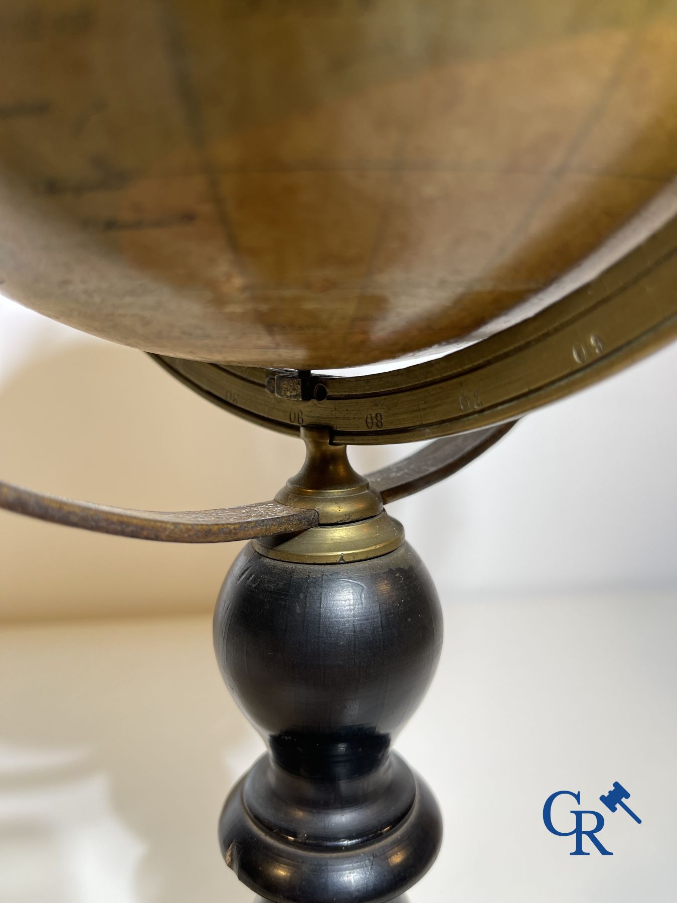 An antique globe with meridian circle on a black lacquered wooden base. 19th century.