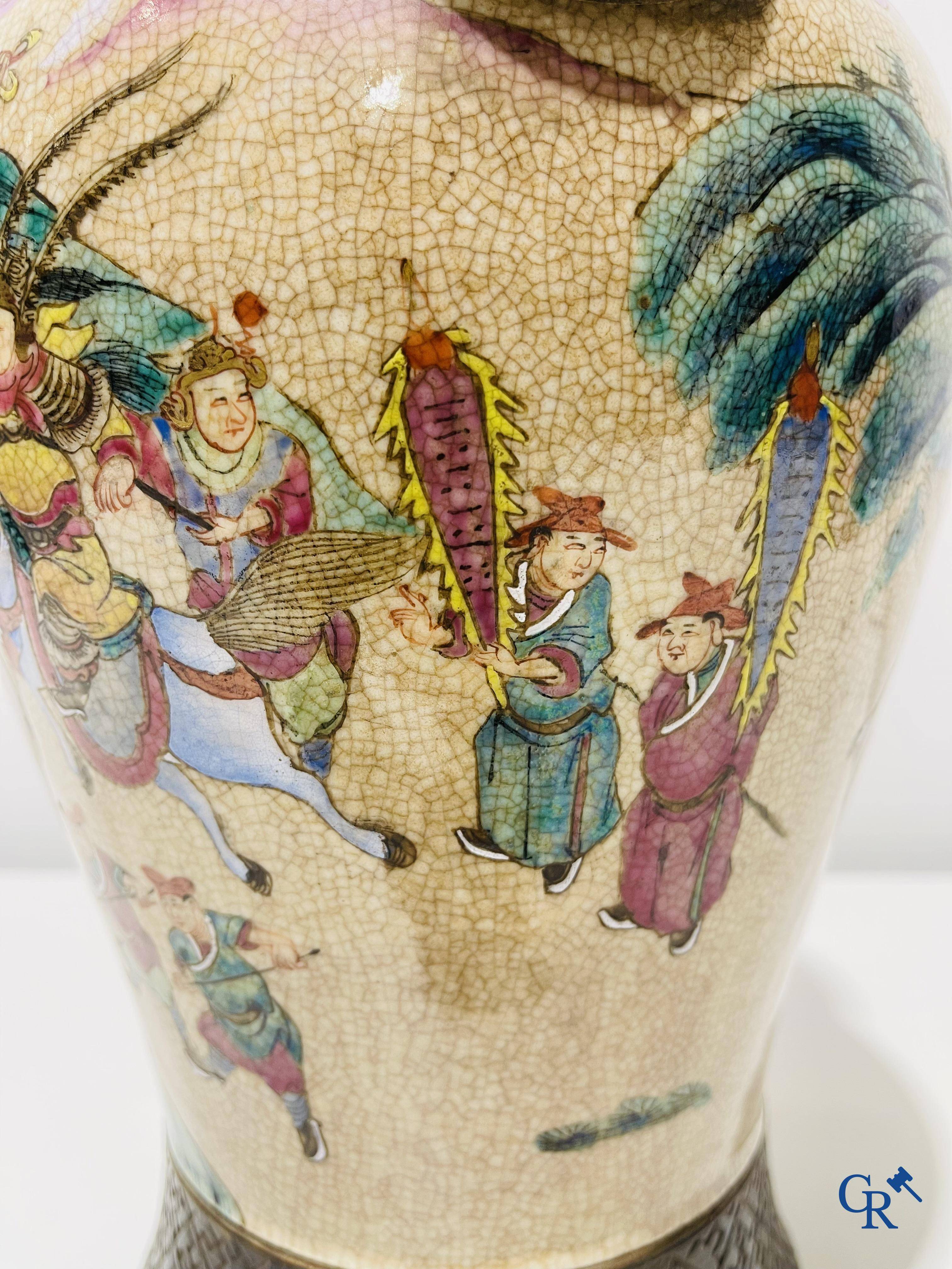 Asian art: A Chinese Nanking famille rose crackle vase with warrior decor. 19th century.