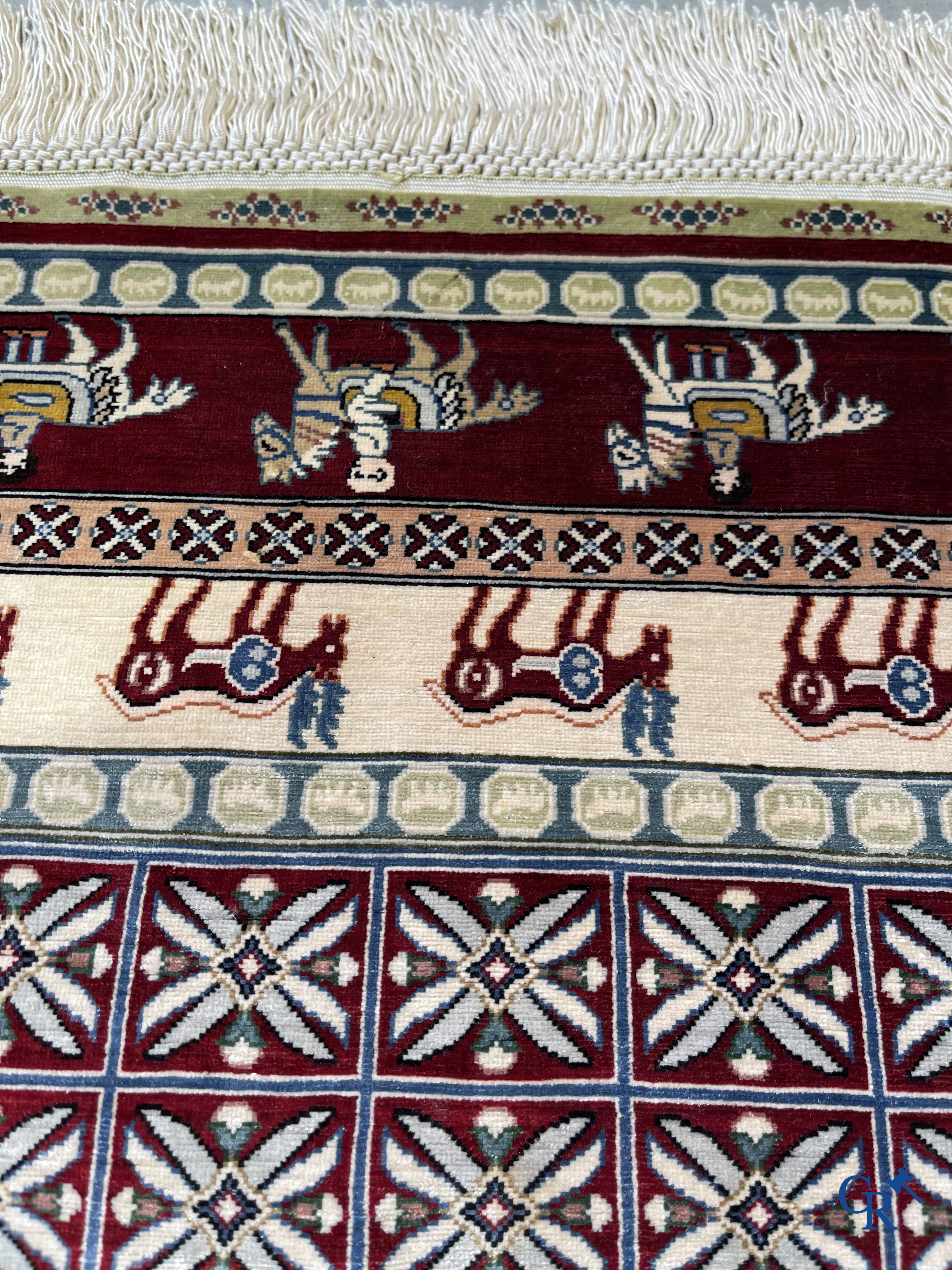 Oriental rugs: A small finely hand-knotted silk rug with deer and horsemen. Signed.