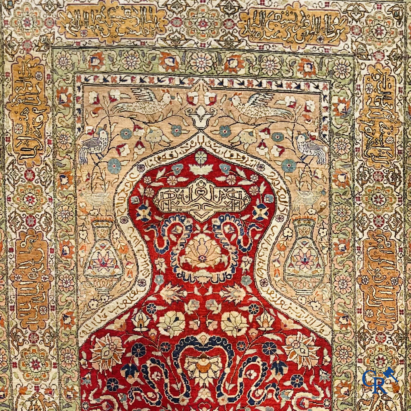 Oriental carpets: Hereke, a finely knotted silk carpet with inscriptions and birds in a floral decor.