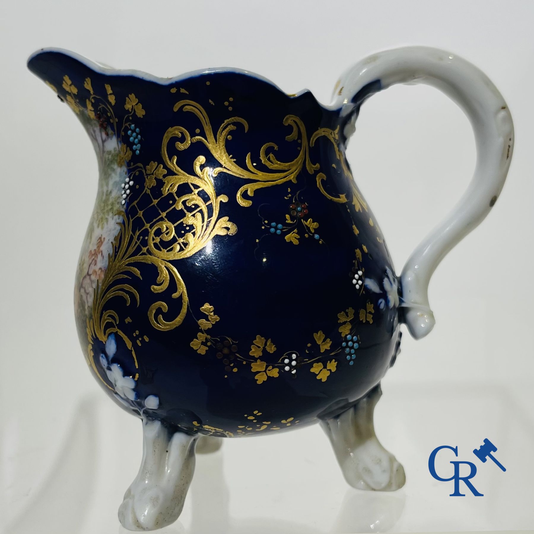 Vincennes 18th century. A three-legged milk jug in soft porcelain with lapis blue background.