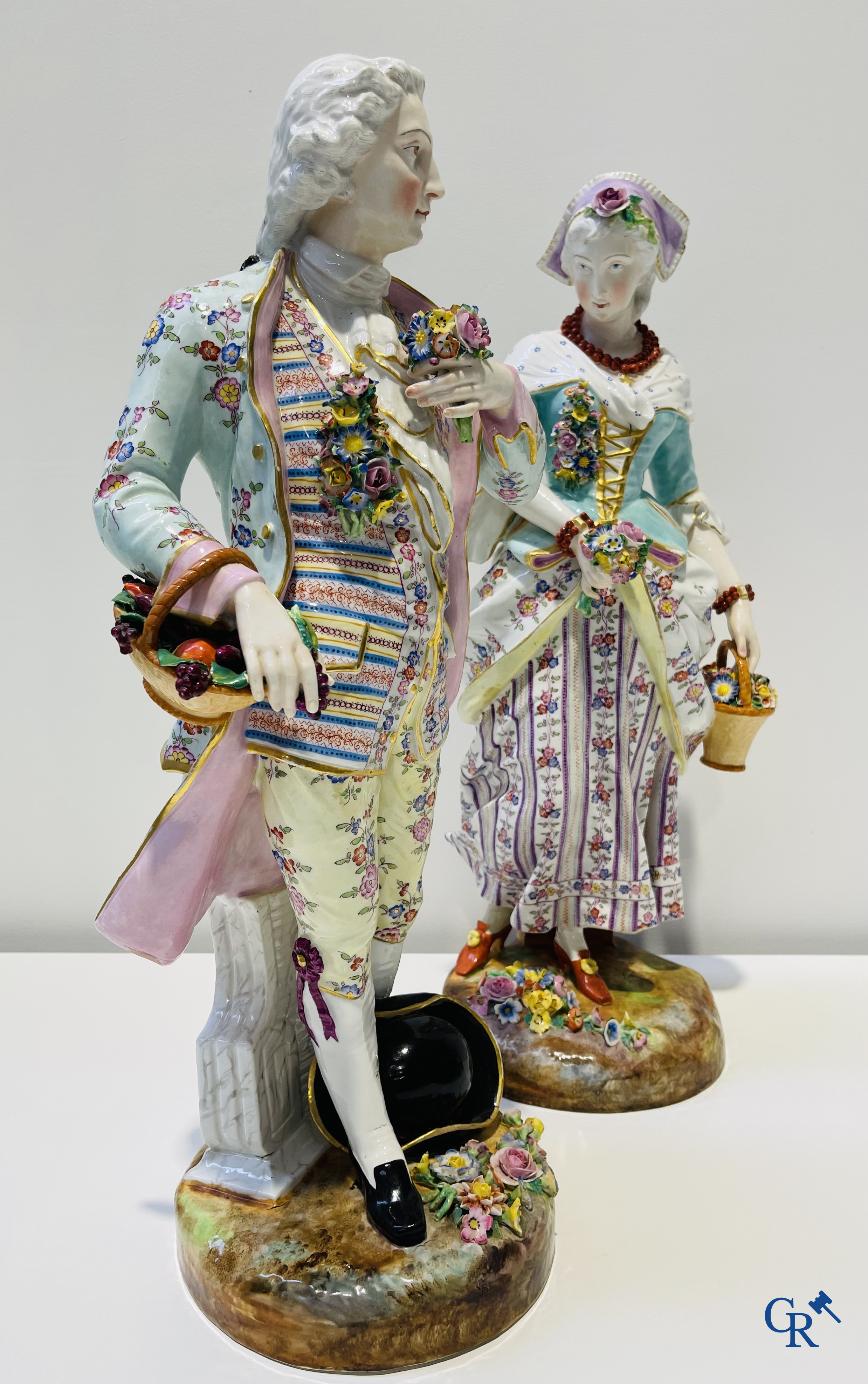 Exceptionally large pair of romantic statues in coloured and gilded porcelain in the manner of Meissen.