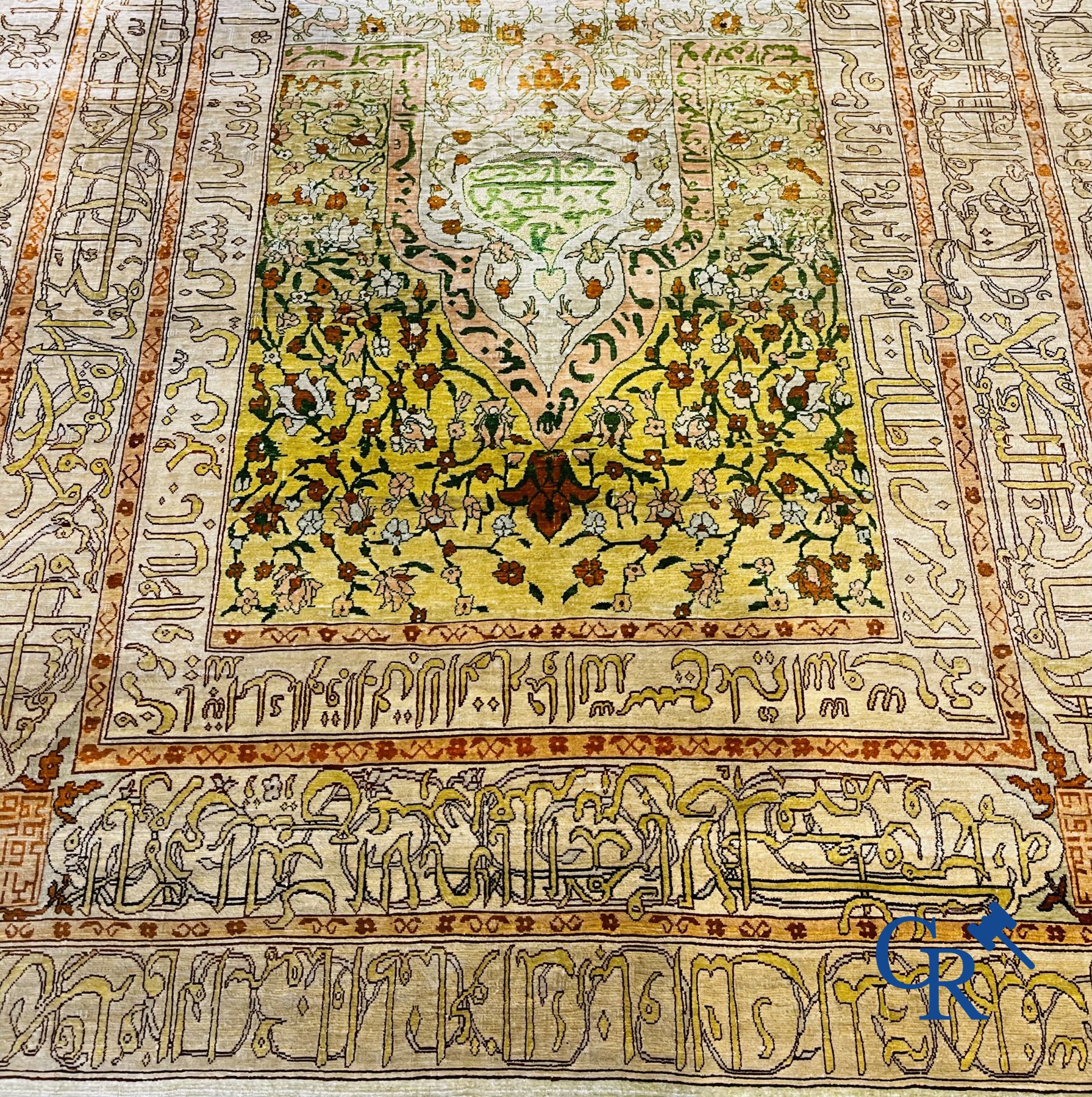 Oriental carpets: An exceptionally signed carpet in silk and gold thread with verses and a floral decor.