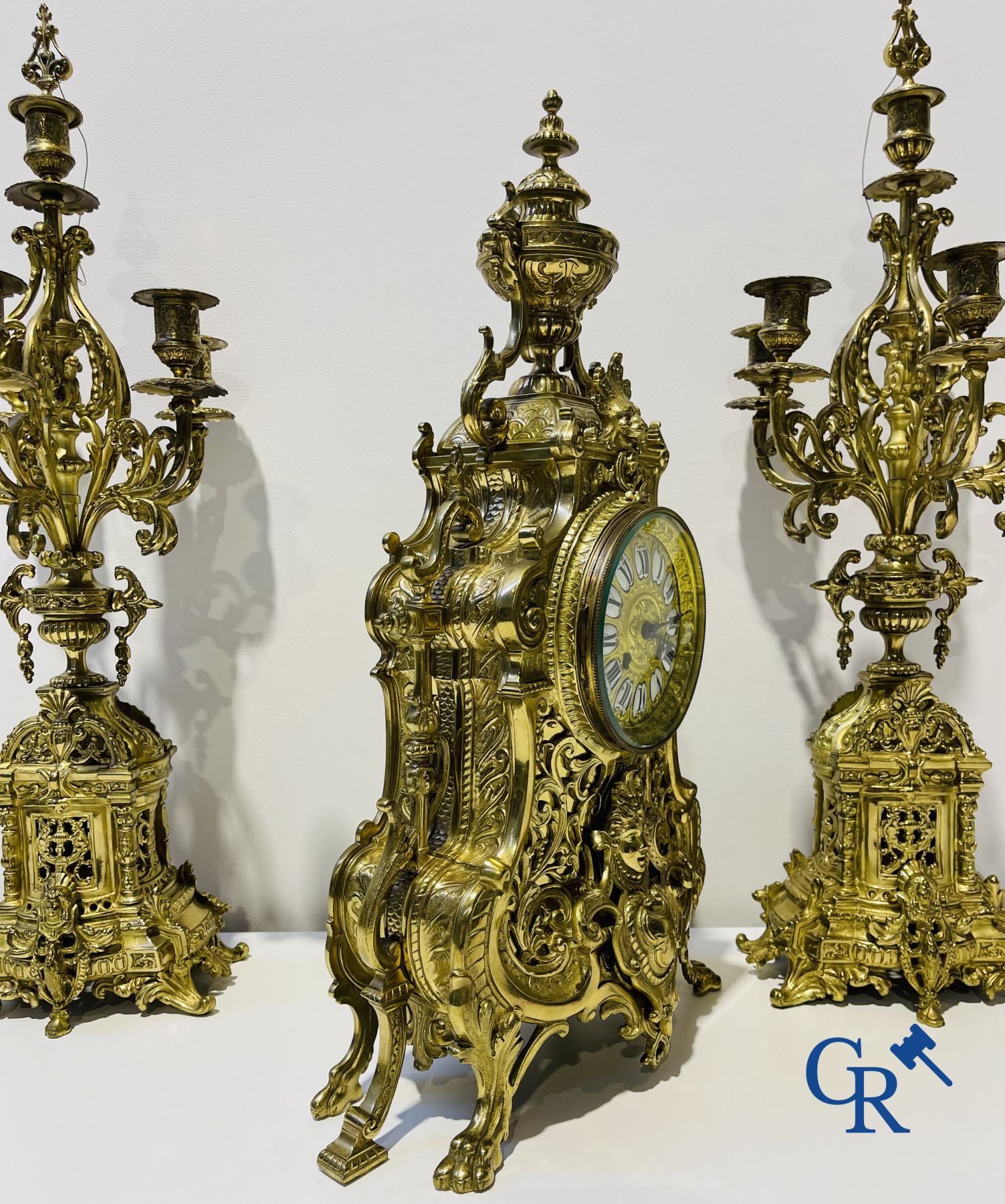 A three-part bronze fireplace clockset in Renaissance style and 2 painted tin and bronze pendant clocks.