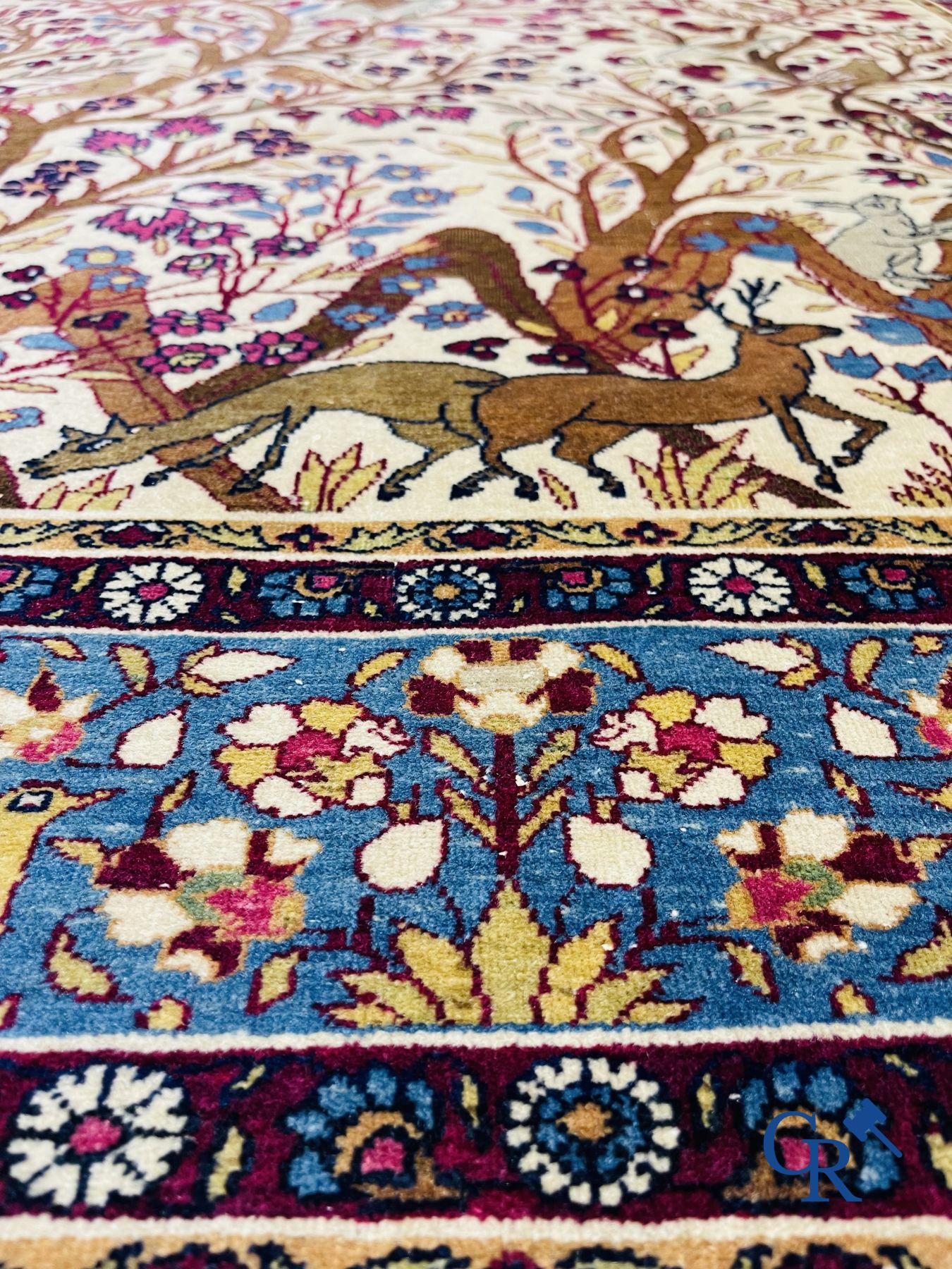 Oriental carpets: Antique oriental carpet with a decor of animals and birds in the forest.