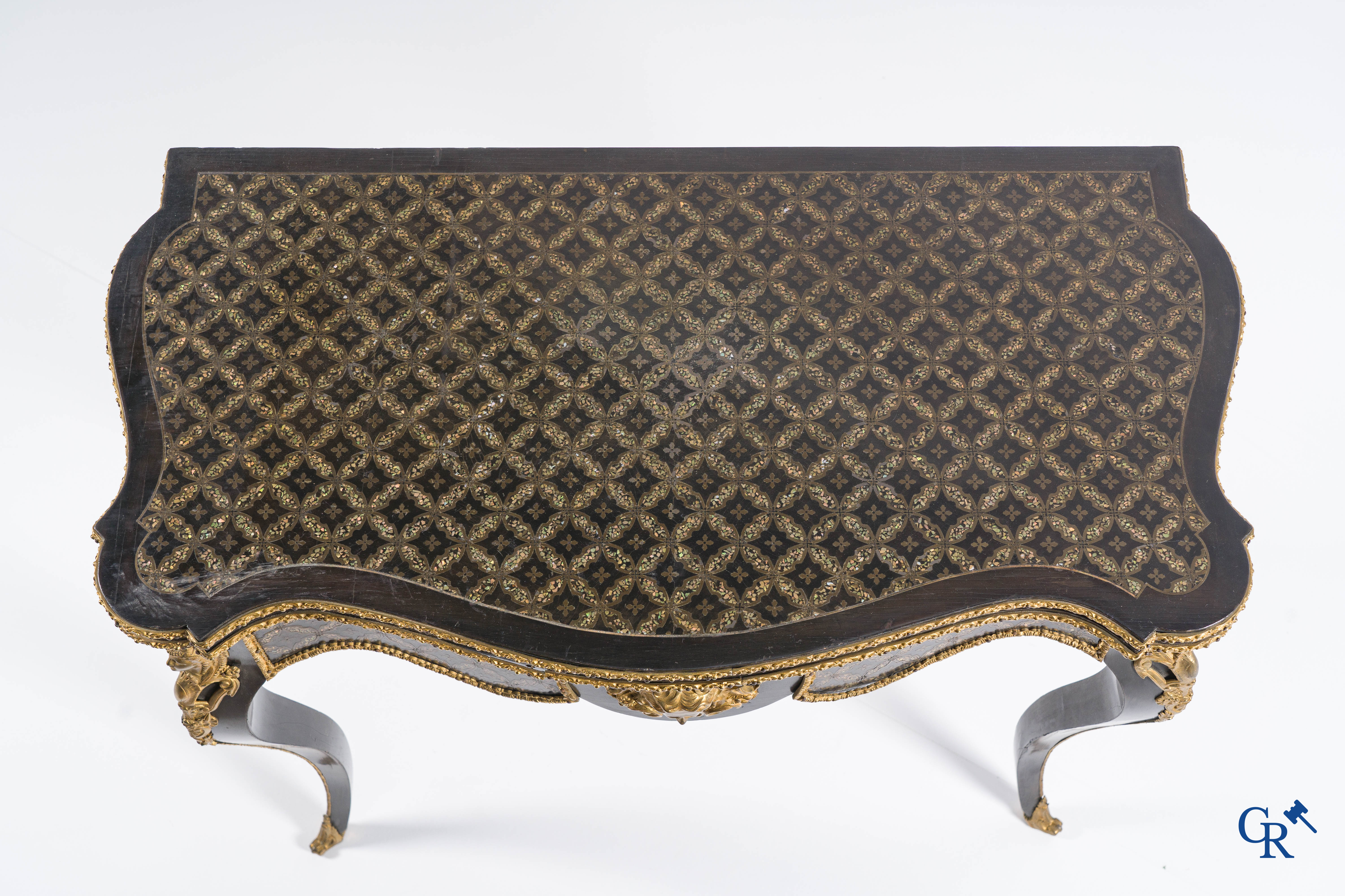 A card table with finely gilded bronze ornaments and inlay of copper and mother-of-pearl, circa 1880.