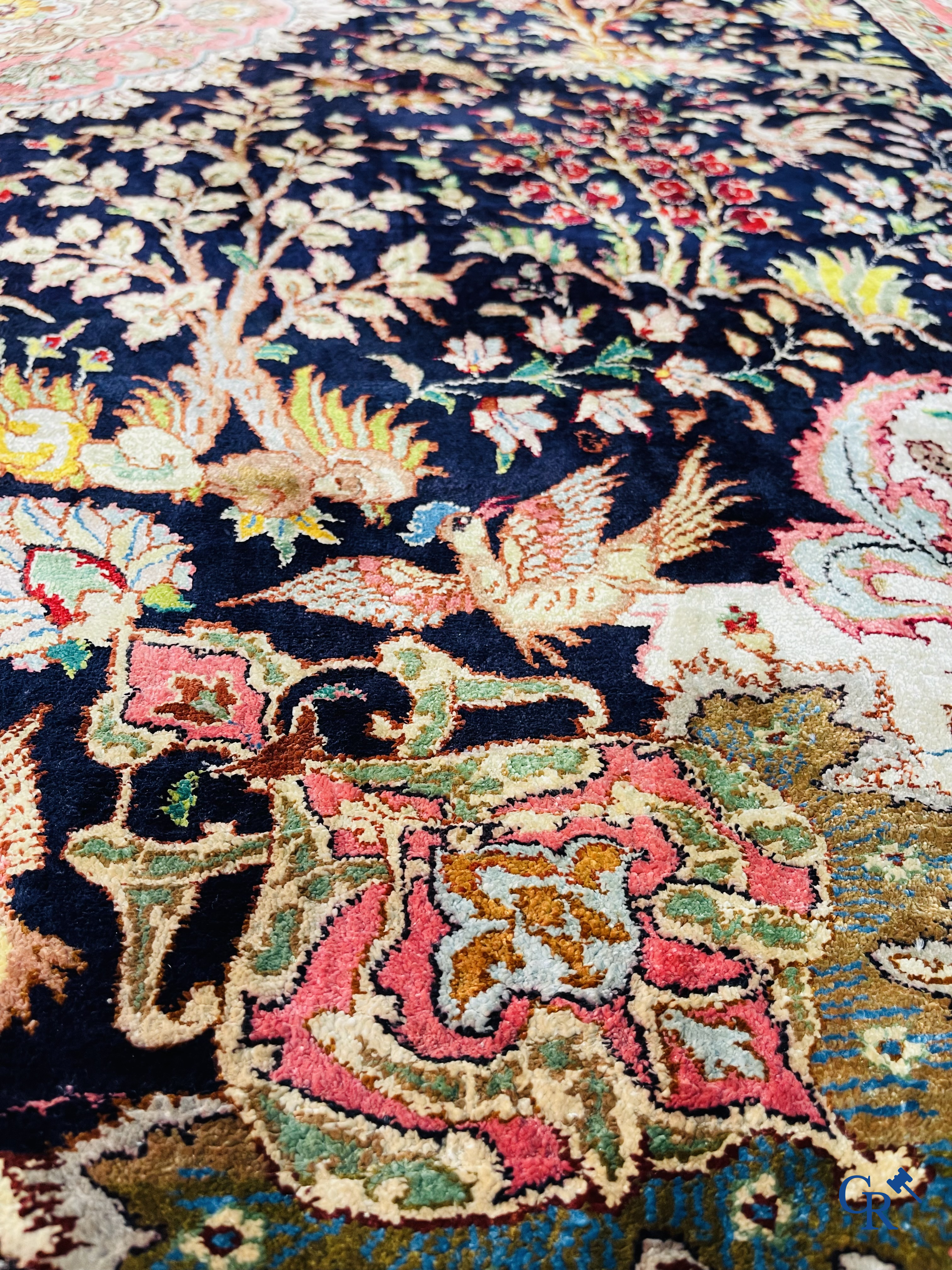 Oriental carpets: Tabriz, a finely hand-knotted silk carpet with forest animals and birds in a floral decor.