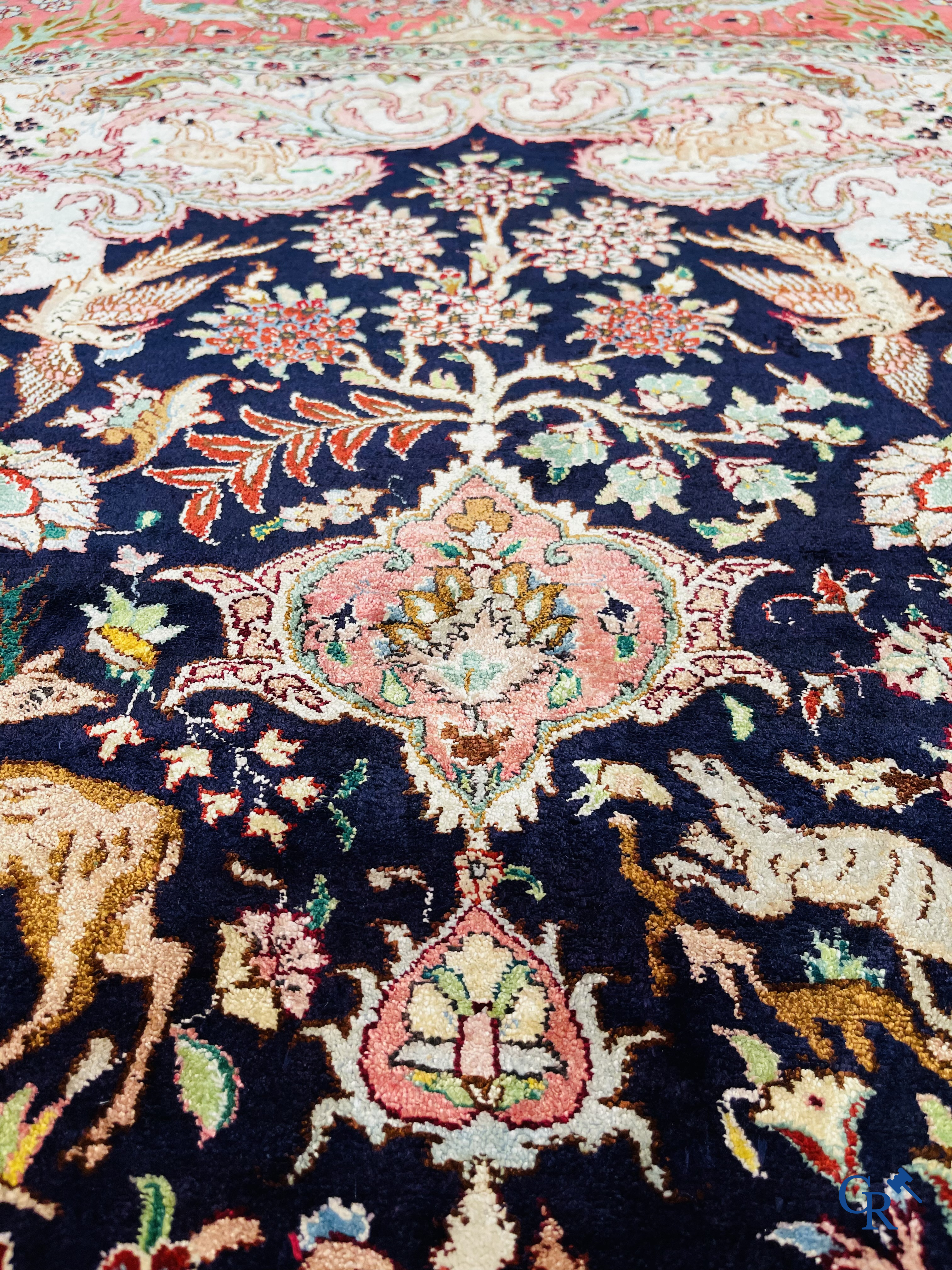 Oriental carpets: Tabriz, a finely hand-knotted silk carpet with forest animals and birds in a floral decor.