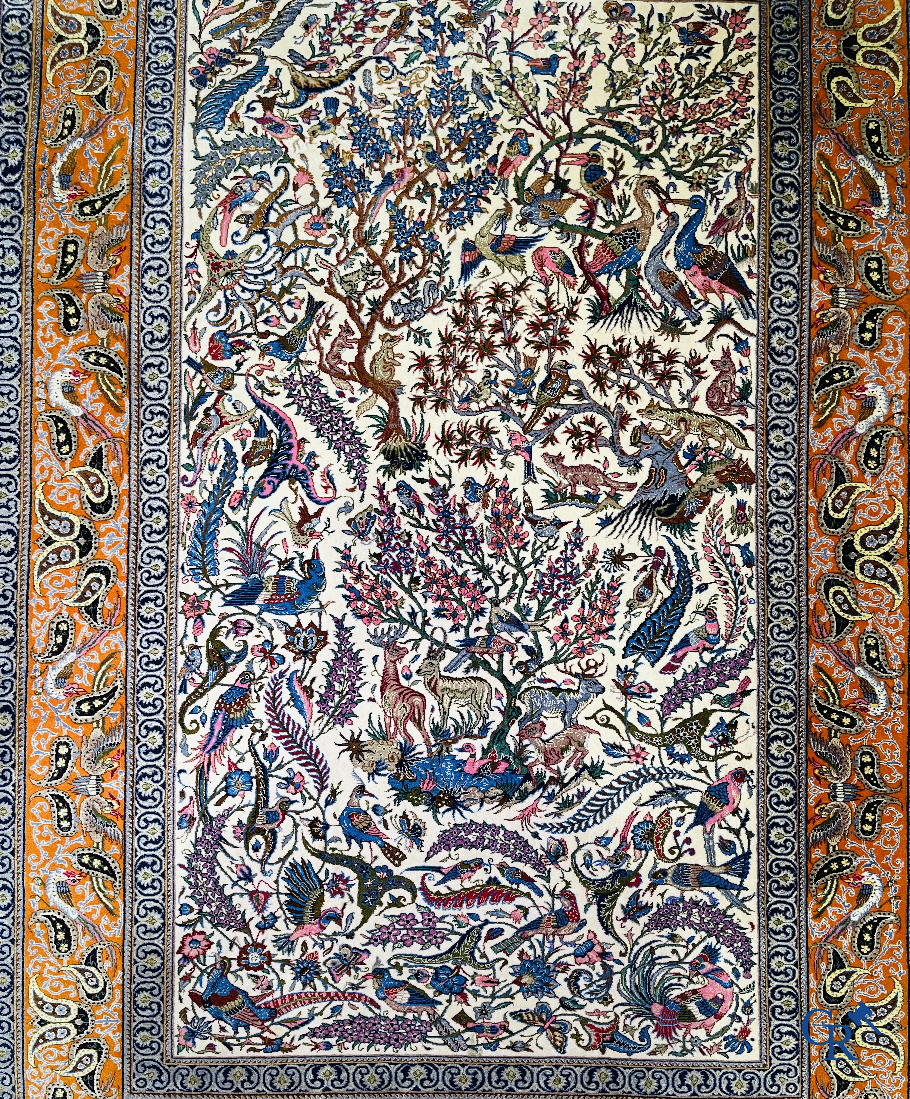 Oriental carpets, a finely hand-knotted silk carpet with forest animals. Signed.