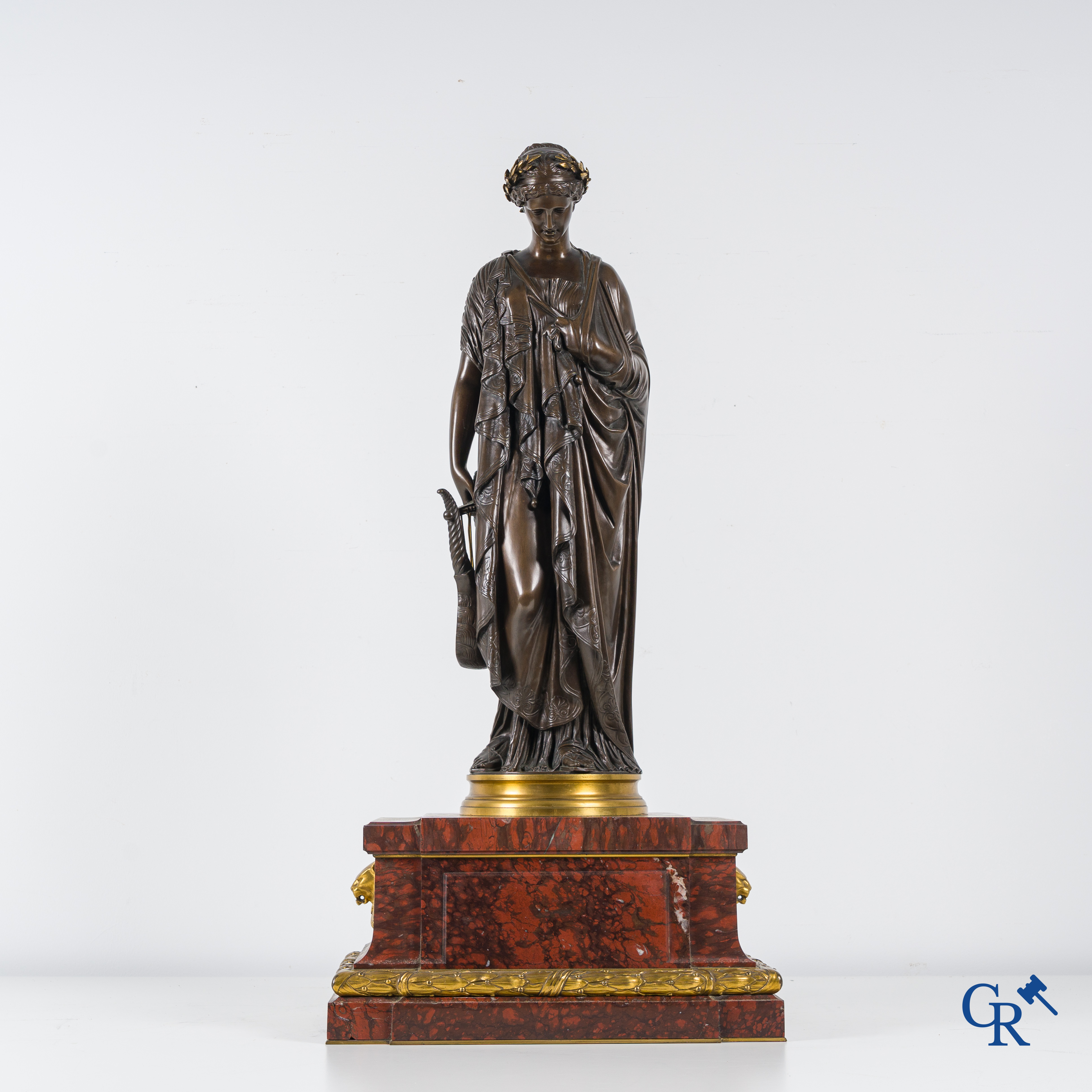 F. Barbedienne Fondeur, a bronze statue in the antique style with brown patina and gilding on a marble pedestal.