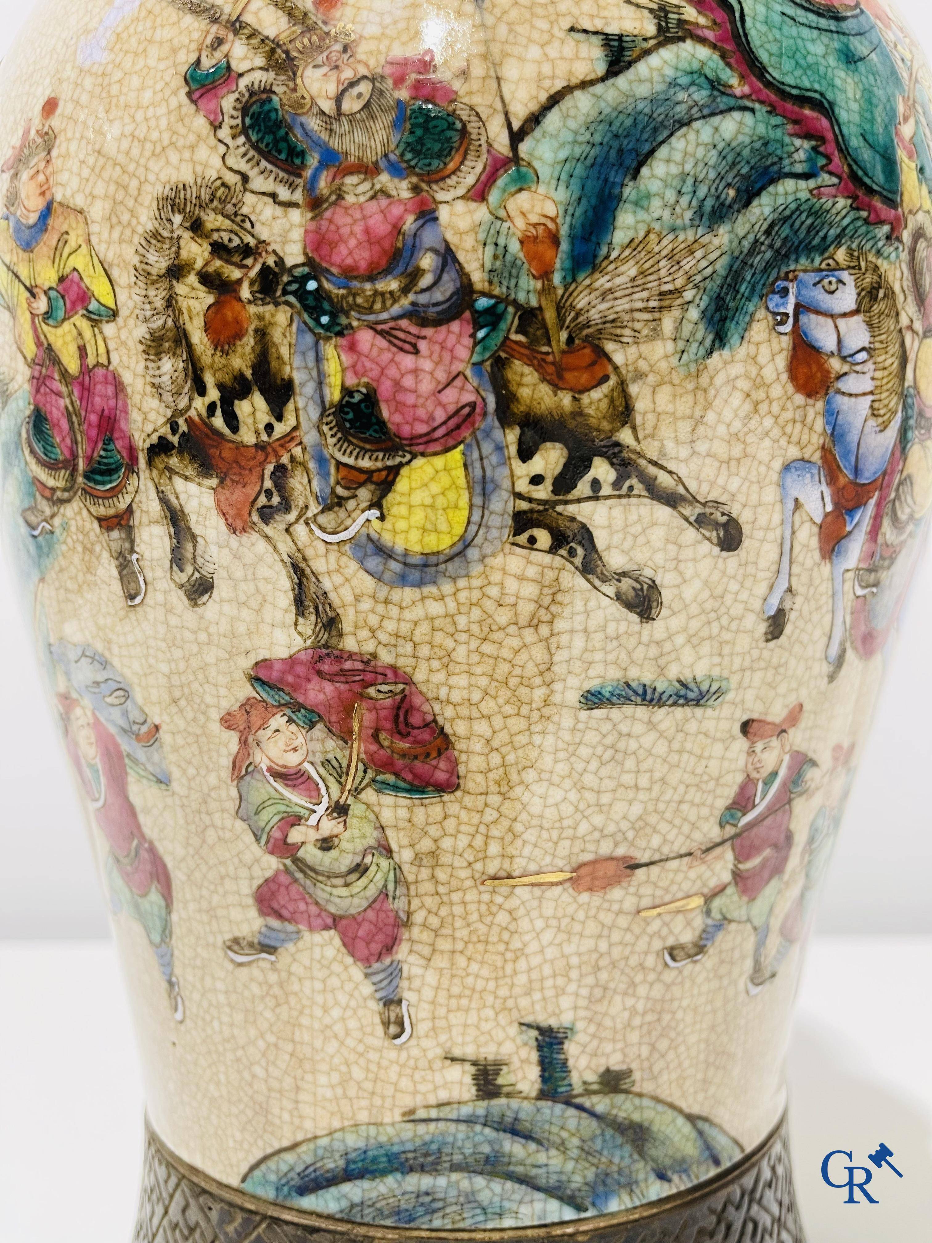 Asian art: A Chinese Nanking famille rose crackle vase with warrior decor. 19th century.