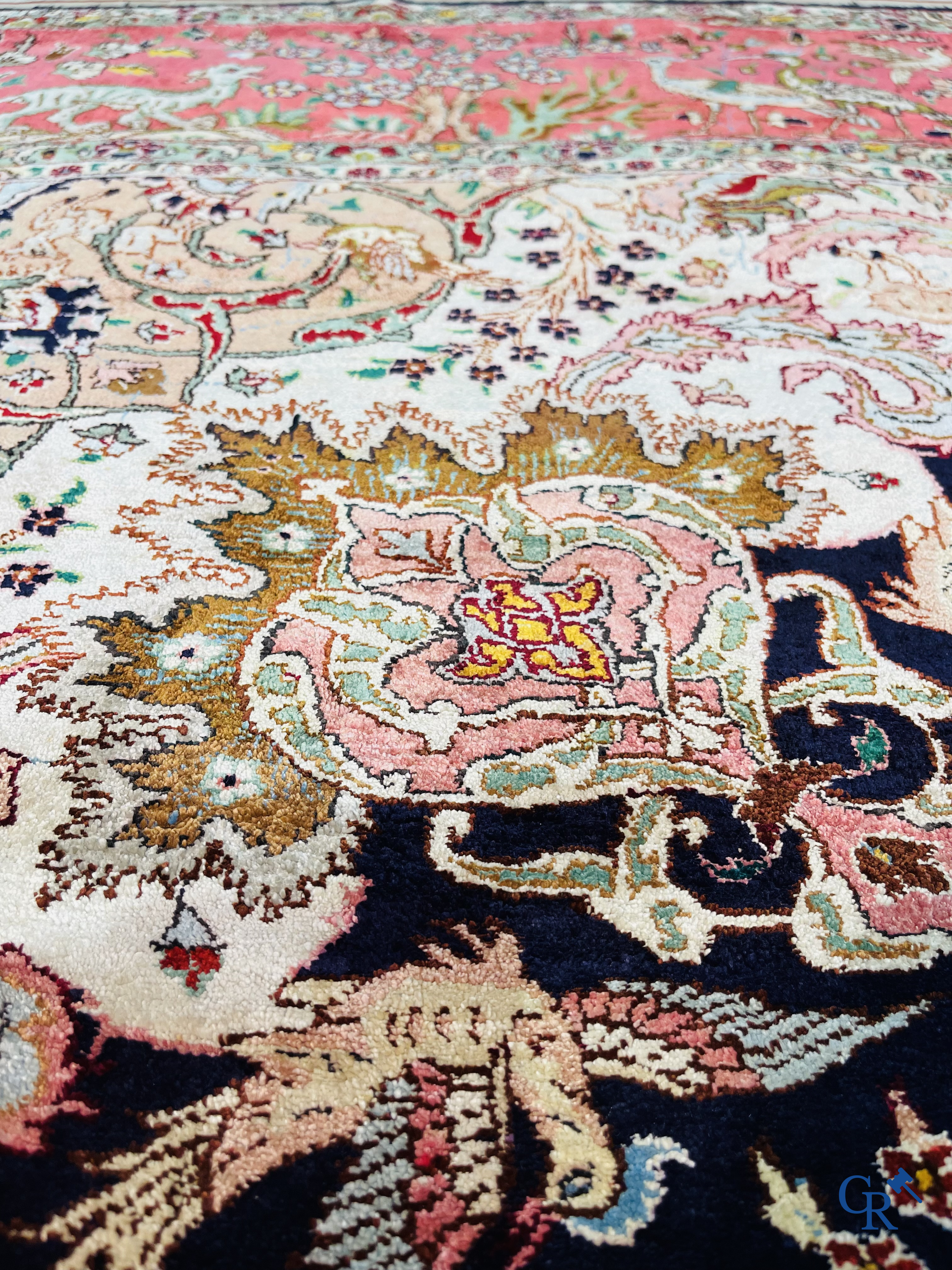 Oriental carpets: Tabriz, a finely hand-knotted silk carpet with forest animals and birds in a floral decor.