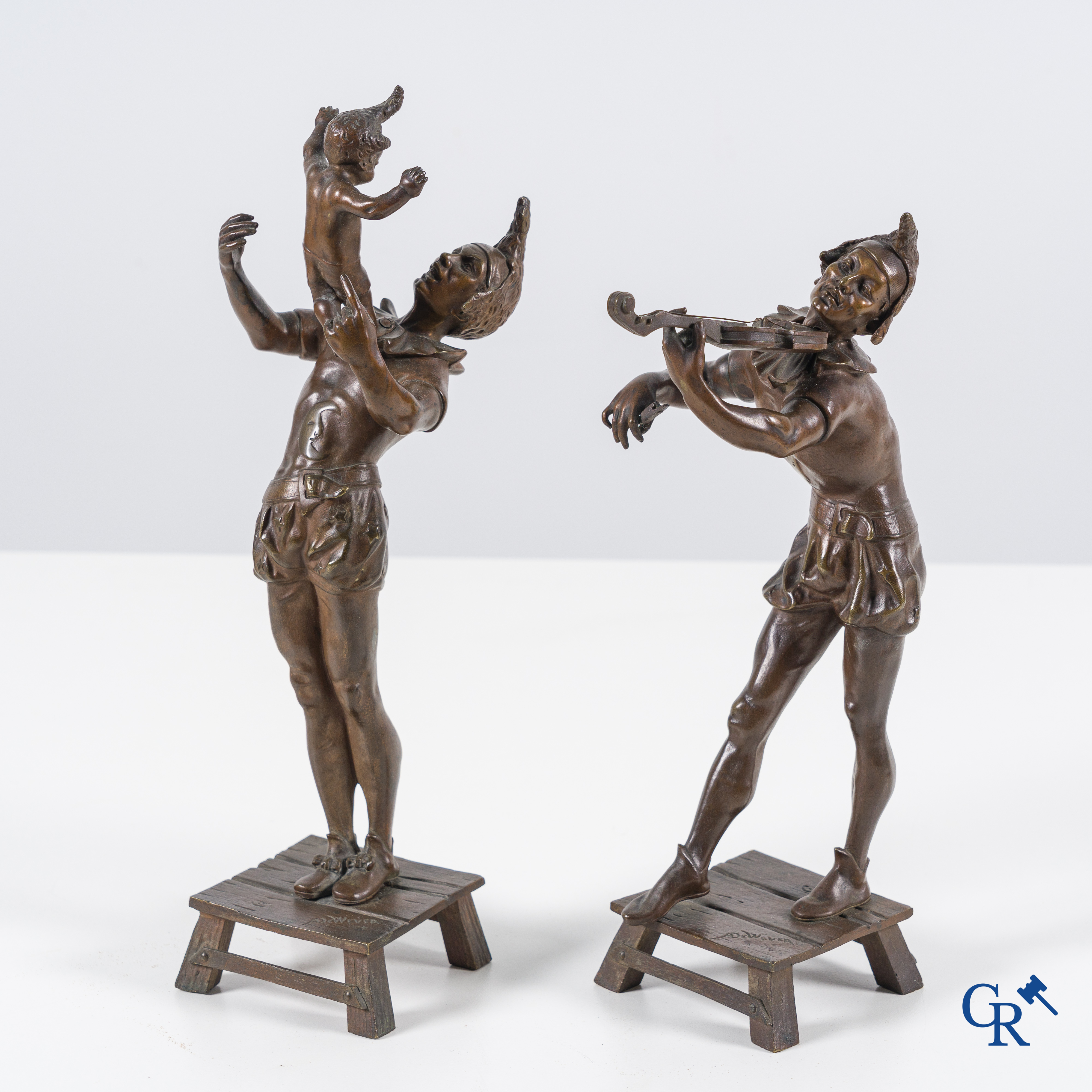 Auguste de Wever (1836-1910) Pair of bronze statues, harlequin with child and music playing harlequin.