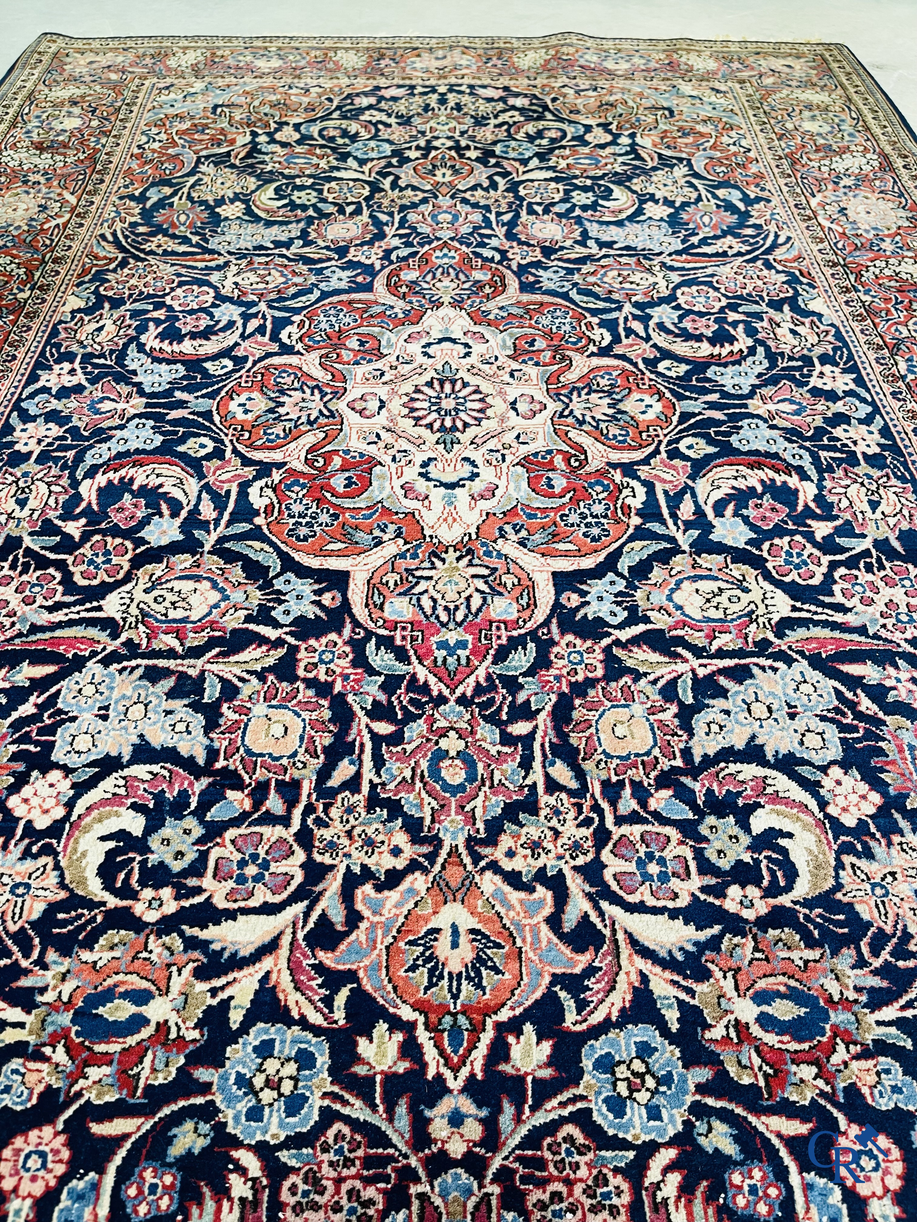 Oriental carpets: Iran. 2 antique hand-knotted Persian carpets with floral decor.