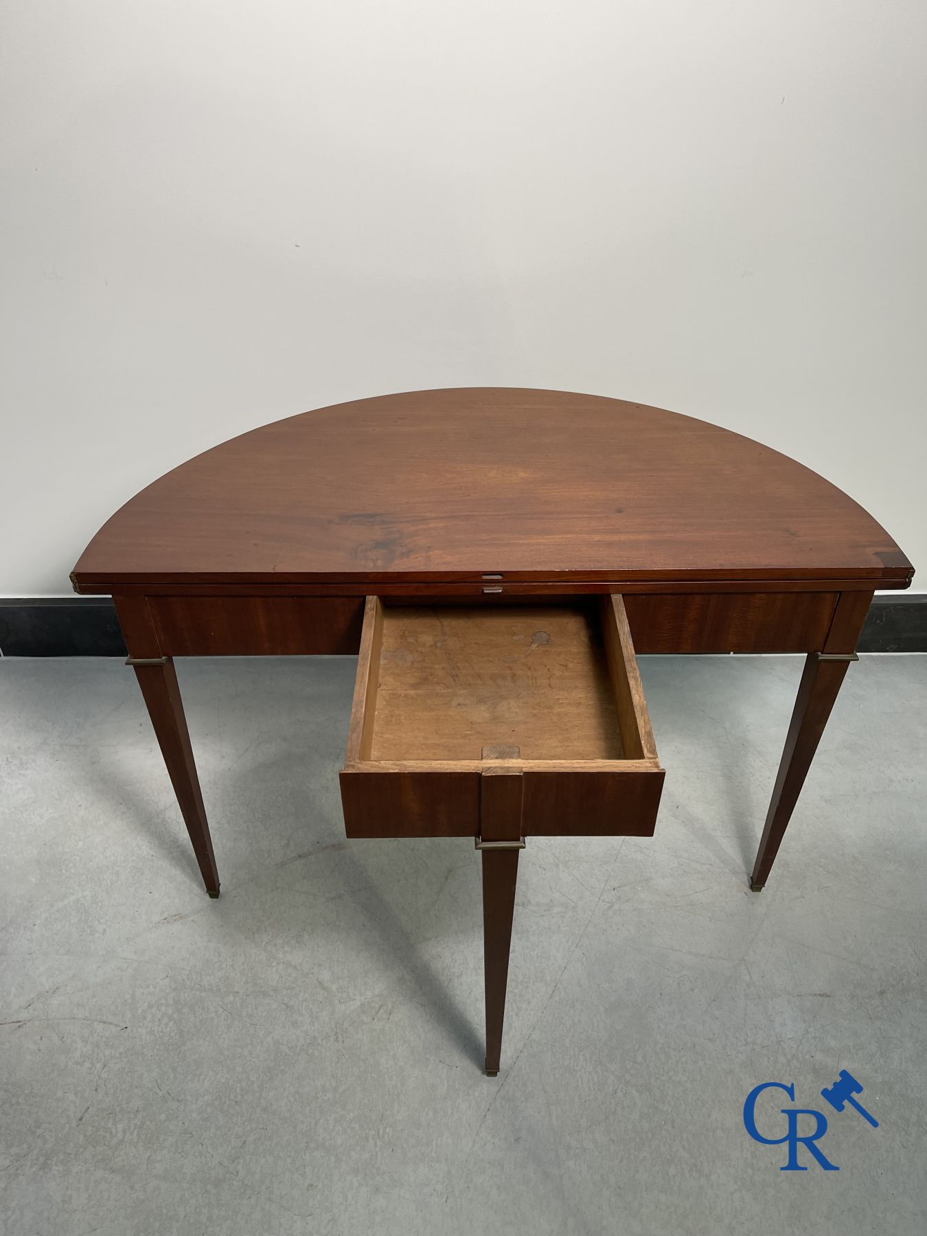 Furniture: fold-out crescent-shaped mahogany table. Directoire period.