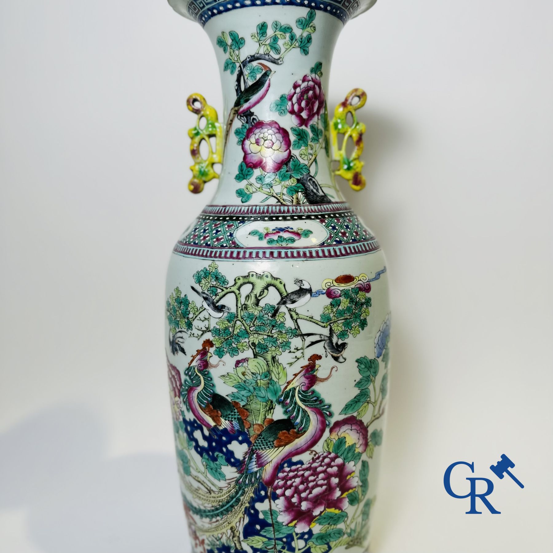 Chinese porcelain: A Chinese famille rose vase with a decor of Buddhist lions, phoenixes, birds and peonies.