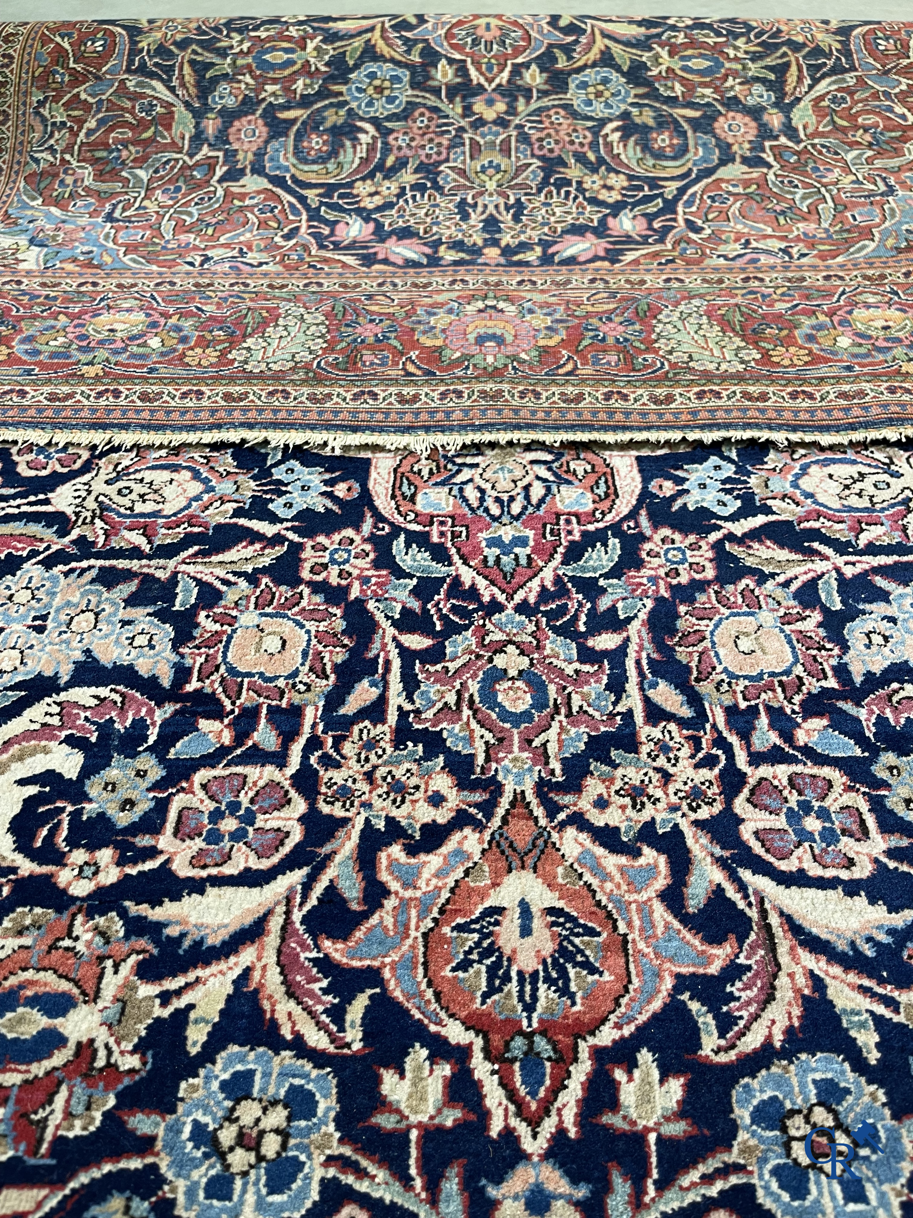 Oriental carpets: Iran. 2 antique hand-knotted Persian carpets with floral decor.