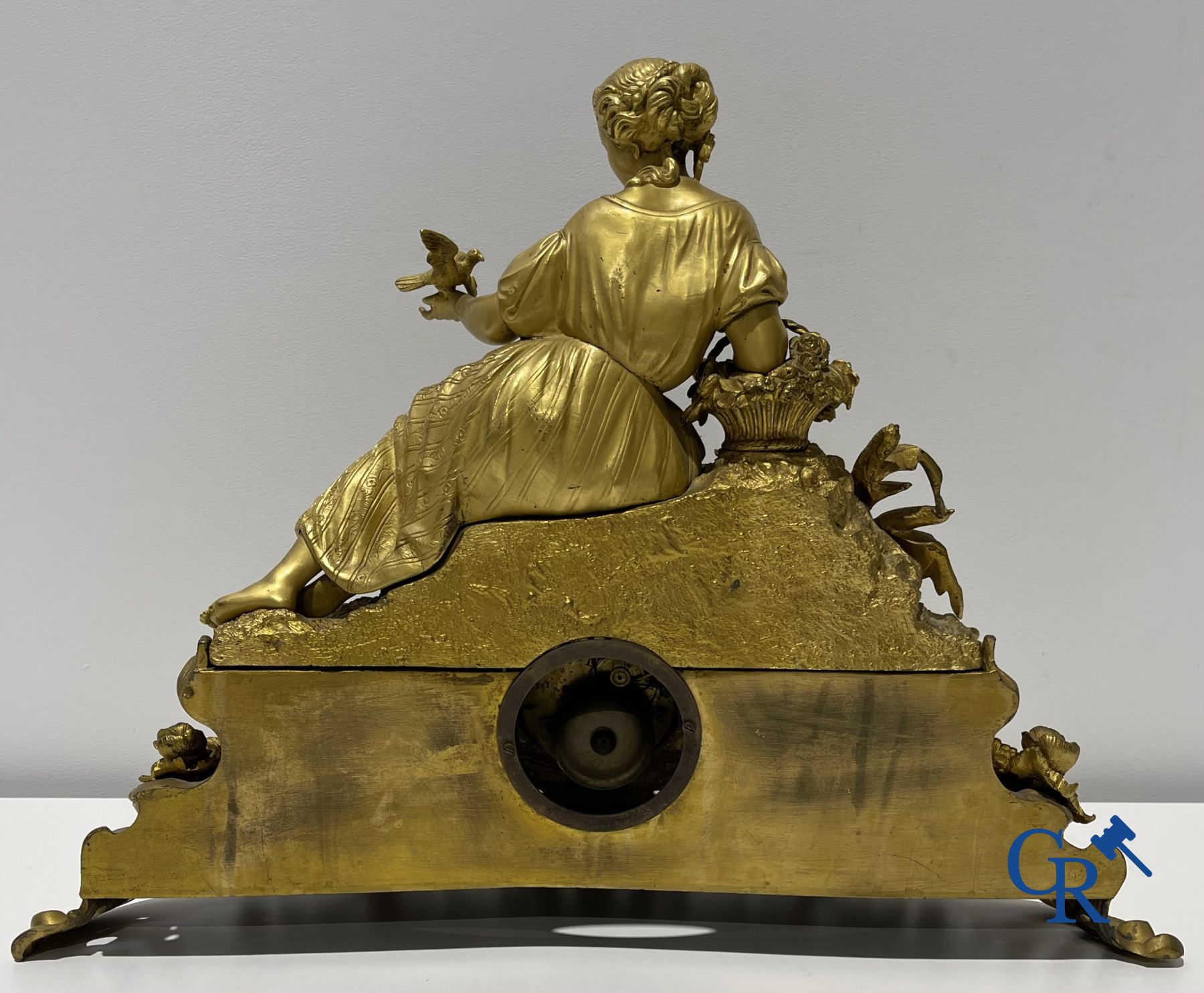 Bronze gilded clock with a romantic performance. 19th century.