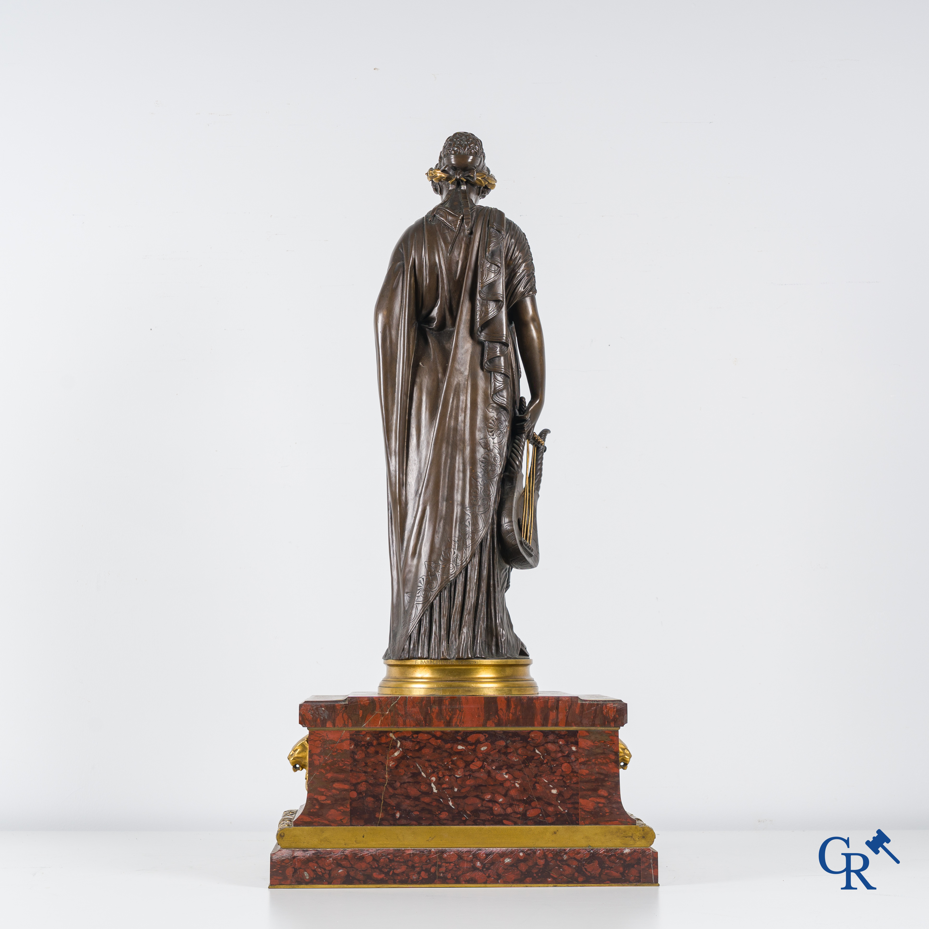 F. Barbedienne Fondeur, a bronze statue in the antique style with brown patina and gilding on a marble pedestal.