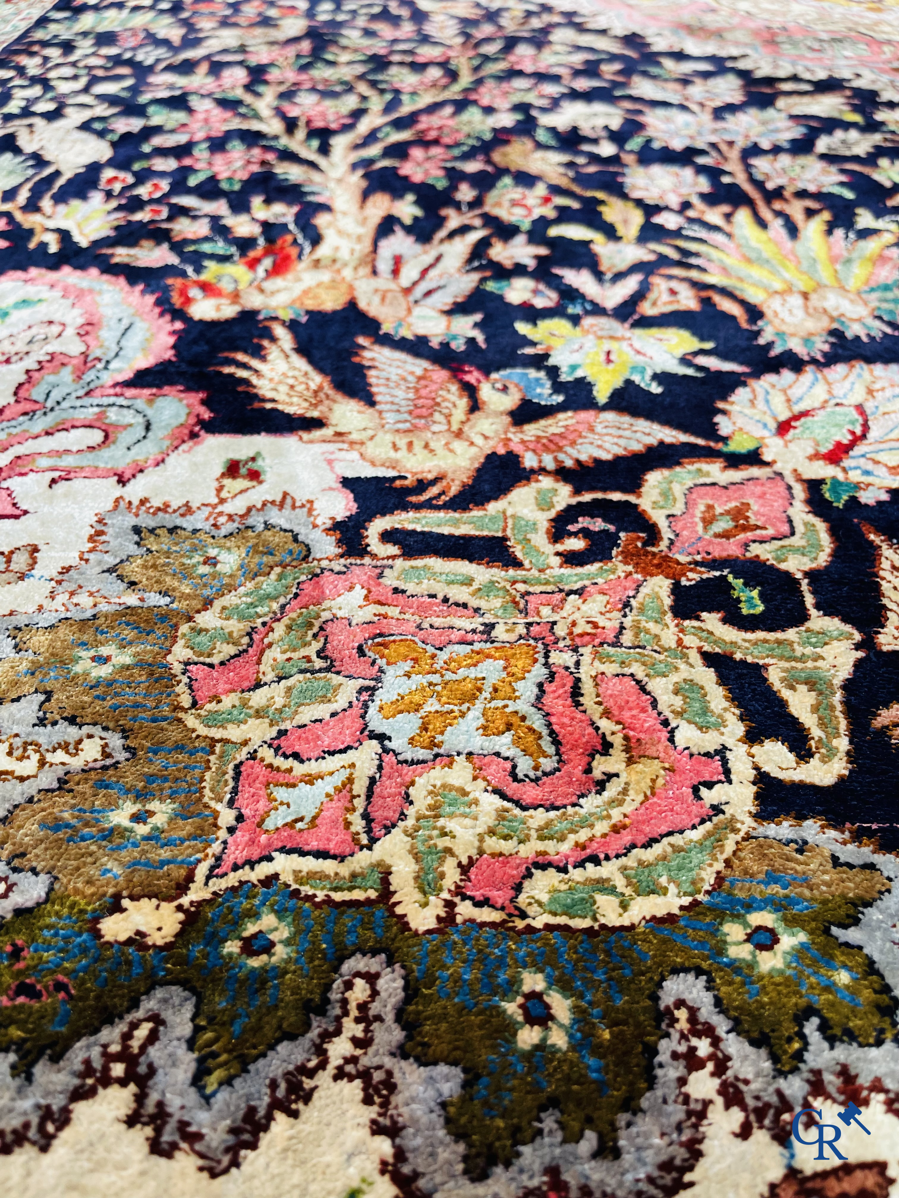 Oriental carpets: Tabriz, a finely hand-knotted silk carpet with forest animals and birds in a floral decor.