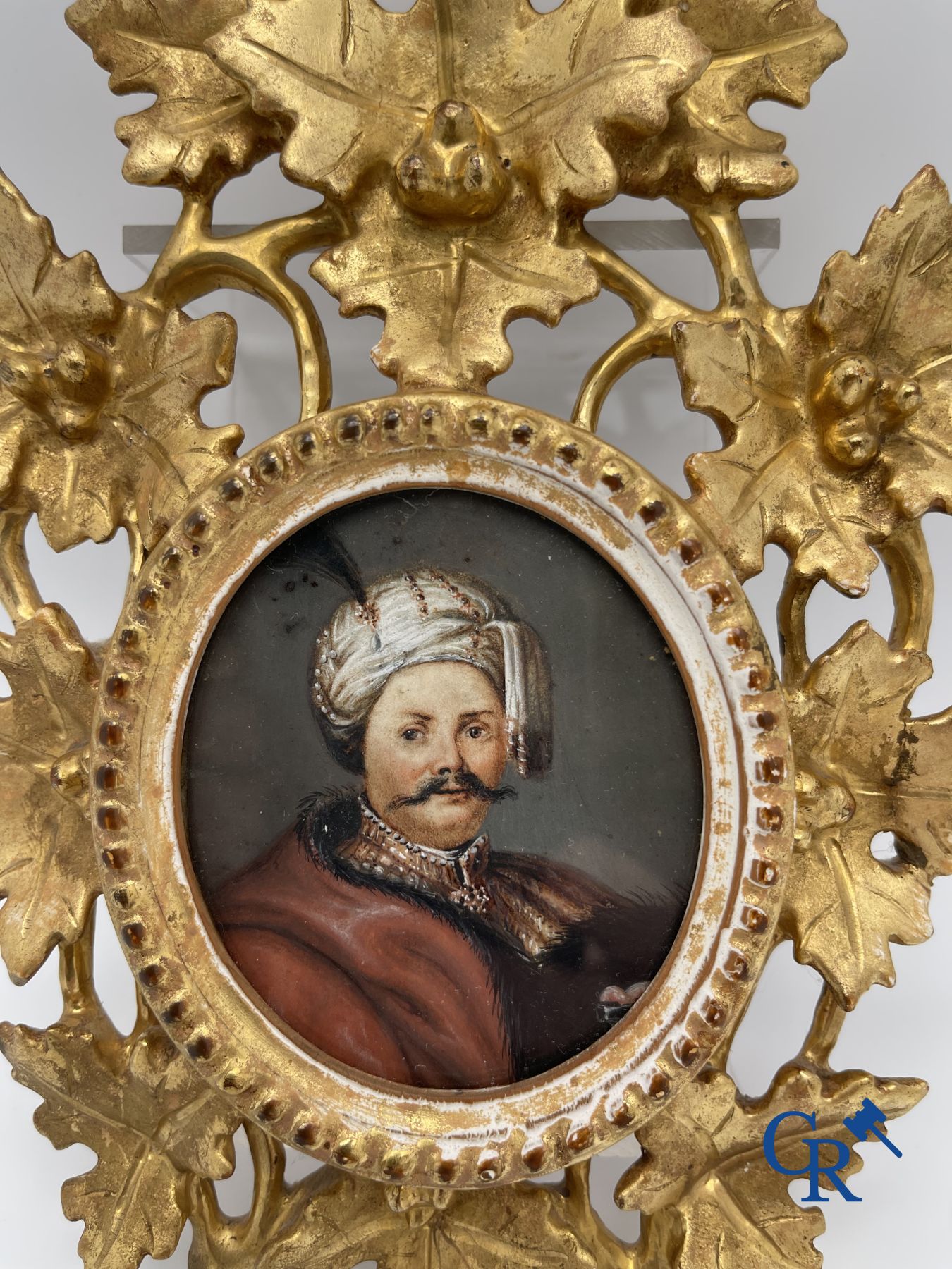 Miniature portrait in a gilded wood-carved frame. 19th century.