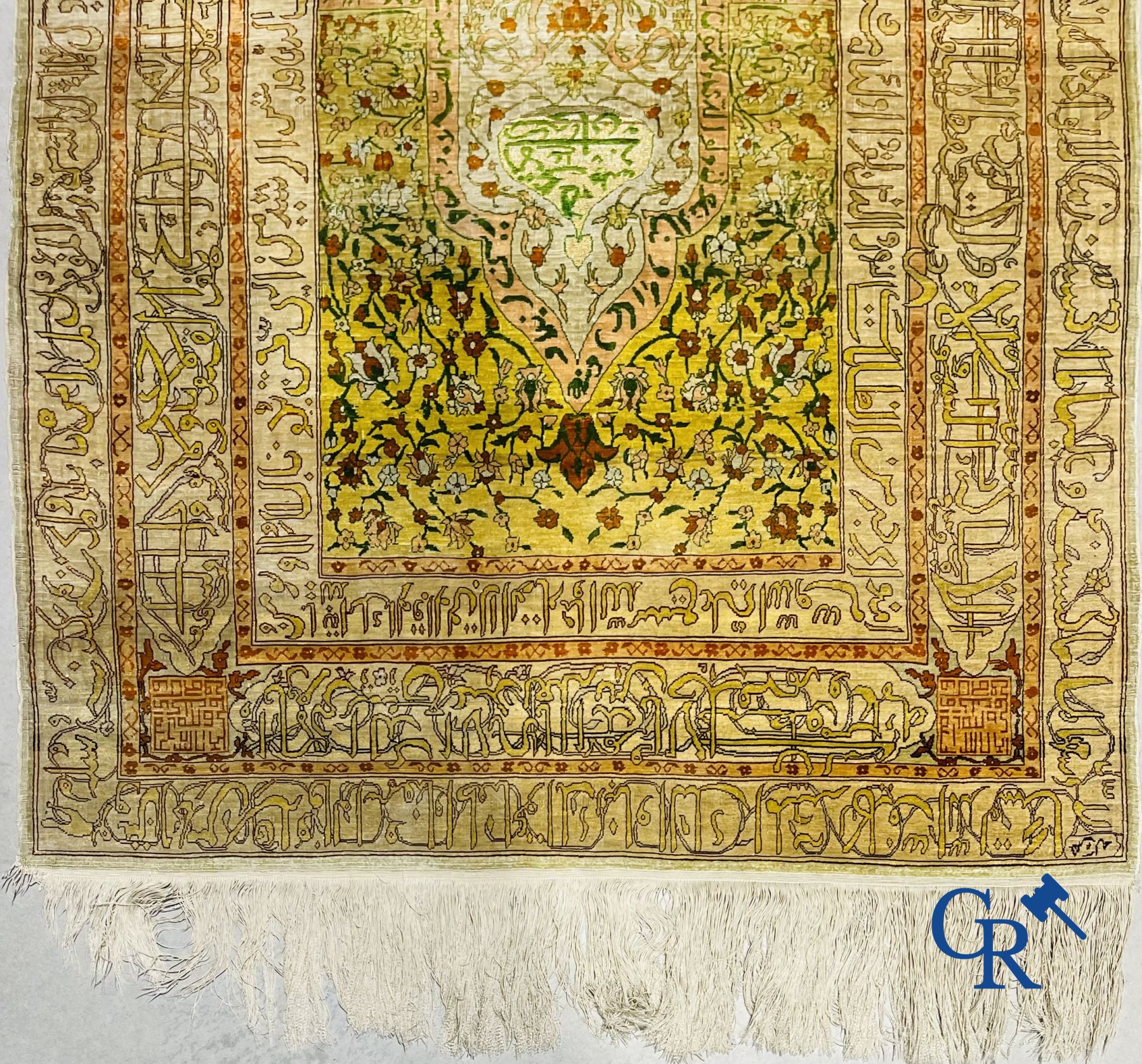 Oriental carpets: An exceptionally signed carpet in silk and gold thread with verses and a floral decor.