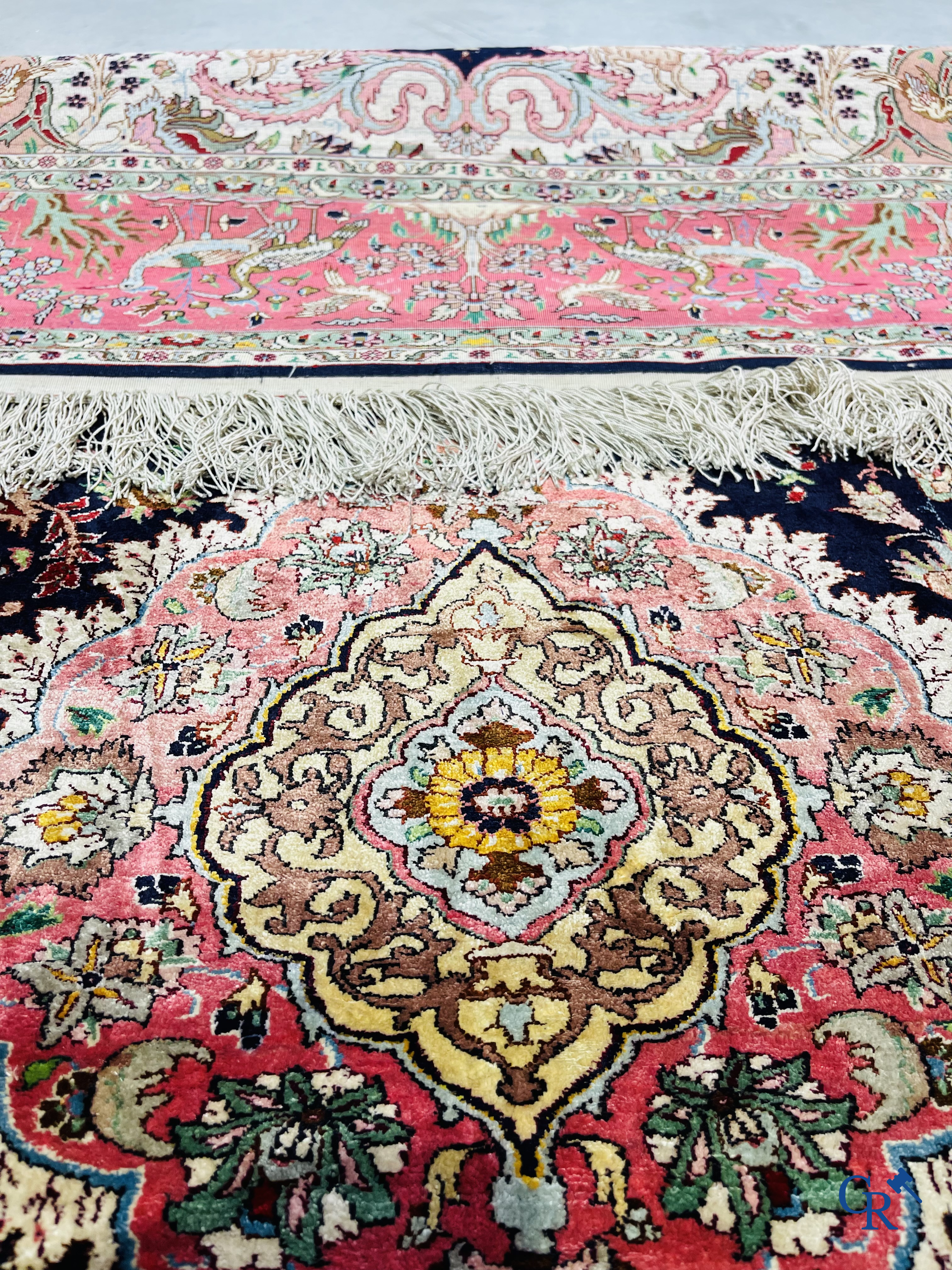 Oriental carpets: Tabriz, a finely hand-knotted silk carpet with forest animals and birds in a floral decor.