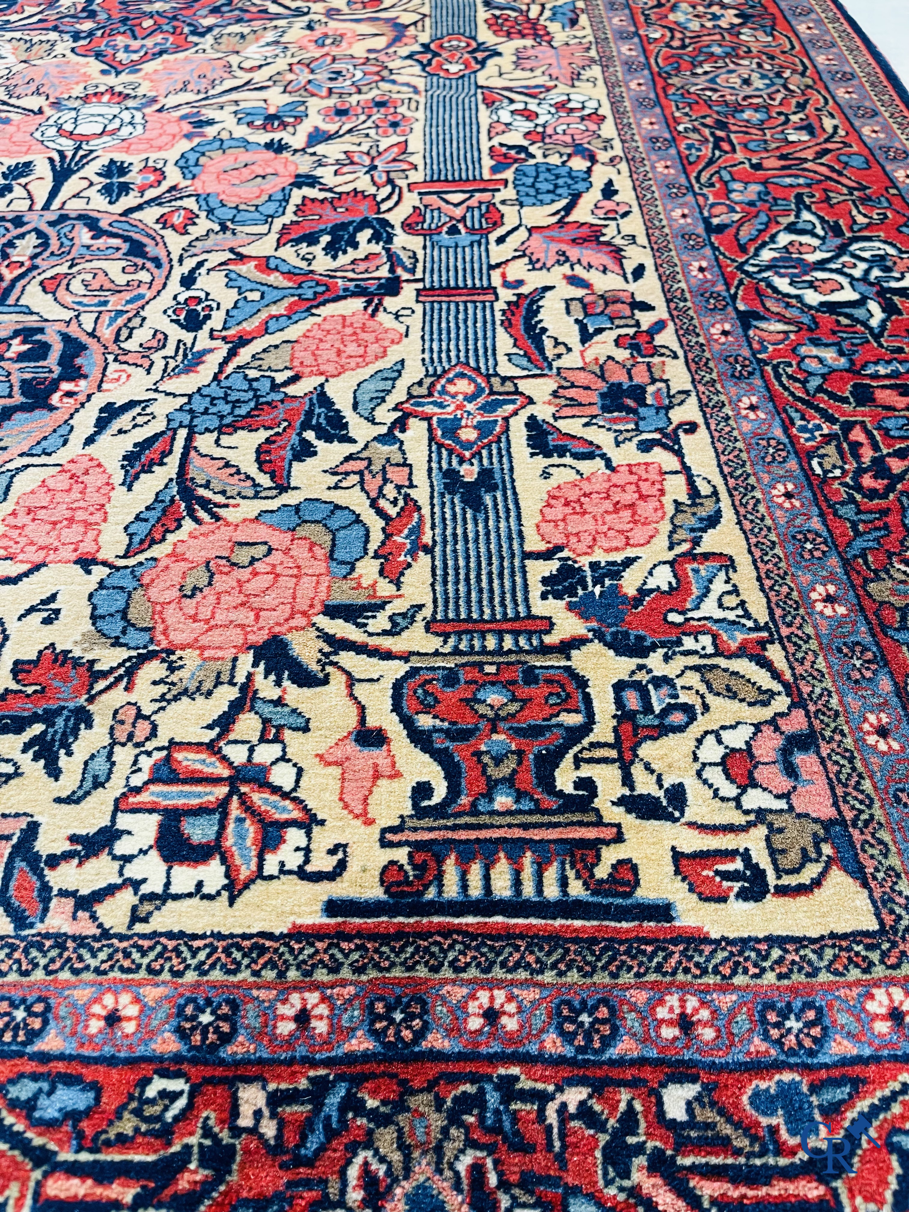 Oriental carpets: Iran. 2 antique hand-knotted Persian carpets with floral decor.