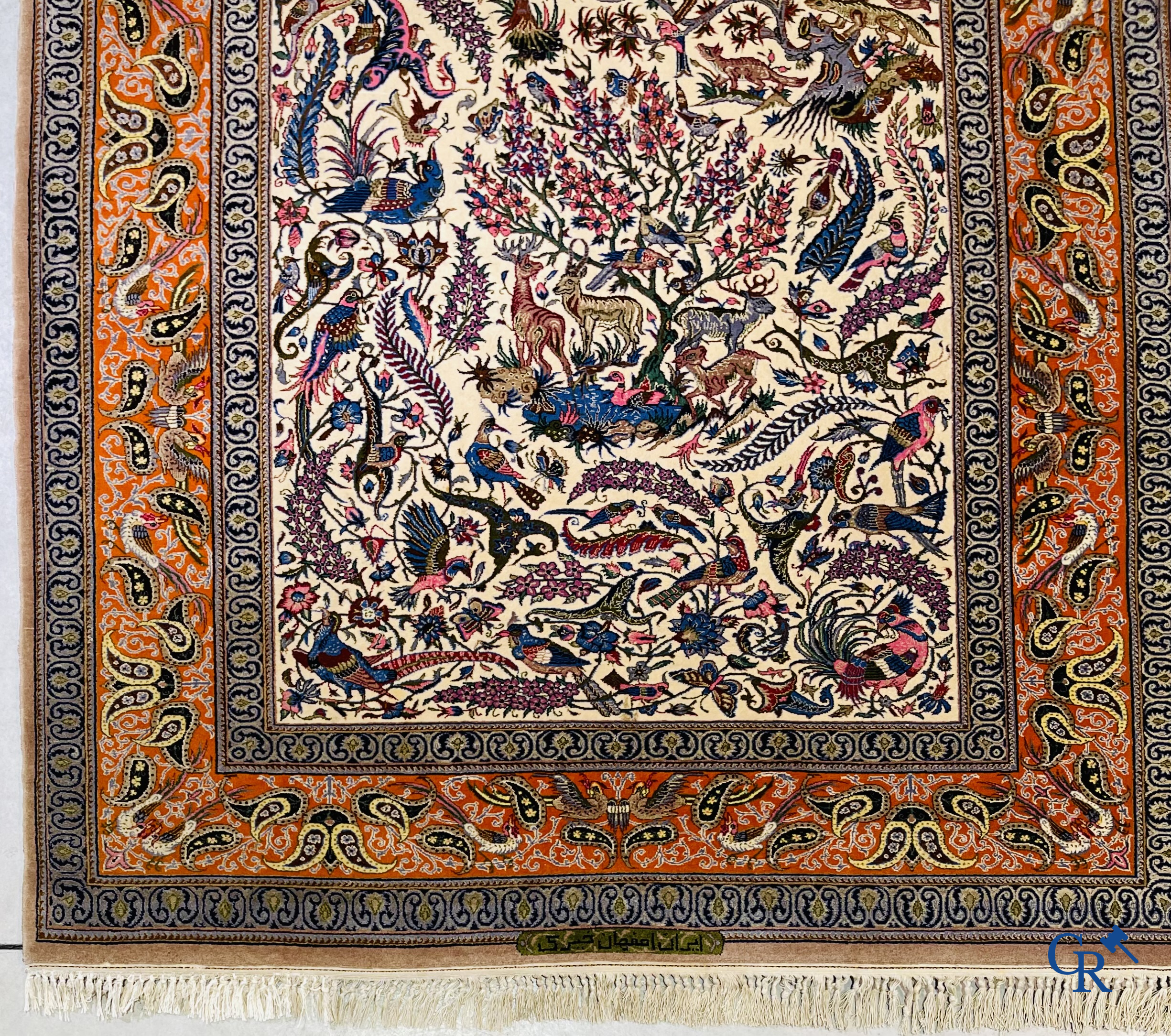 Oriental carpets, a finely hand-knotted silk carpet with forest animals. Signed.