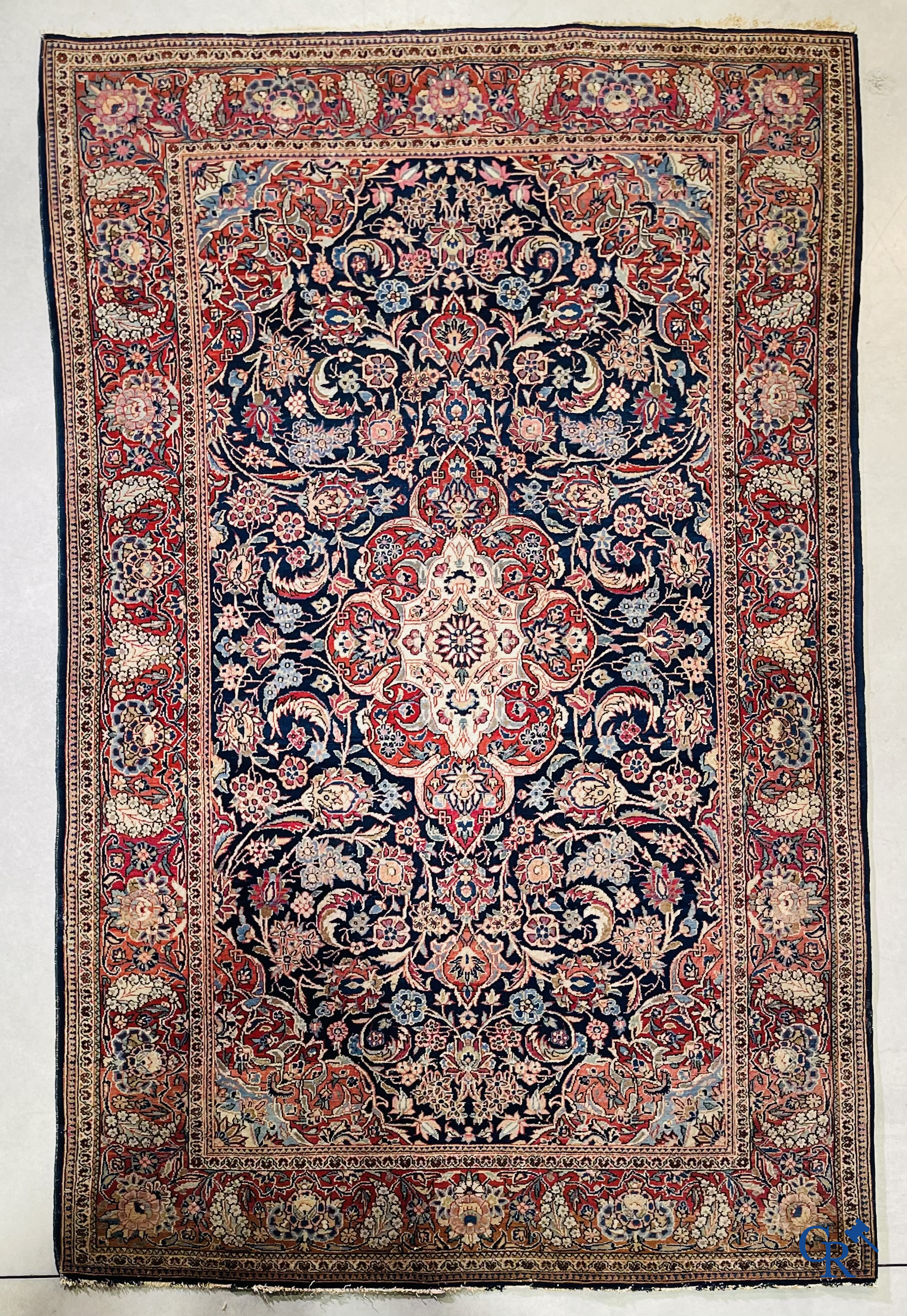 Oriental carpets: Iran. 2 antique hand-knotted Persian carpets with floral decor.