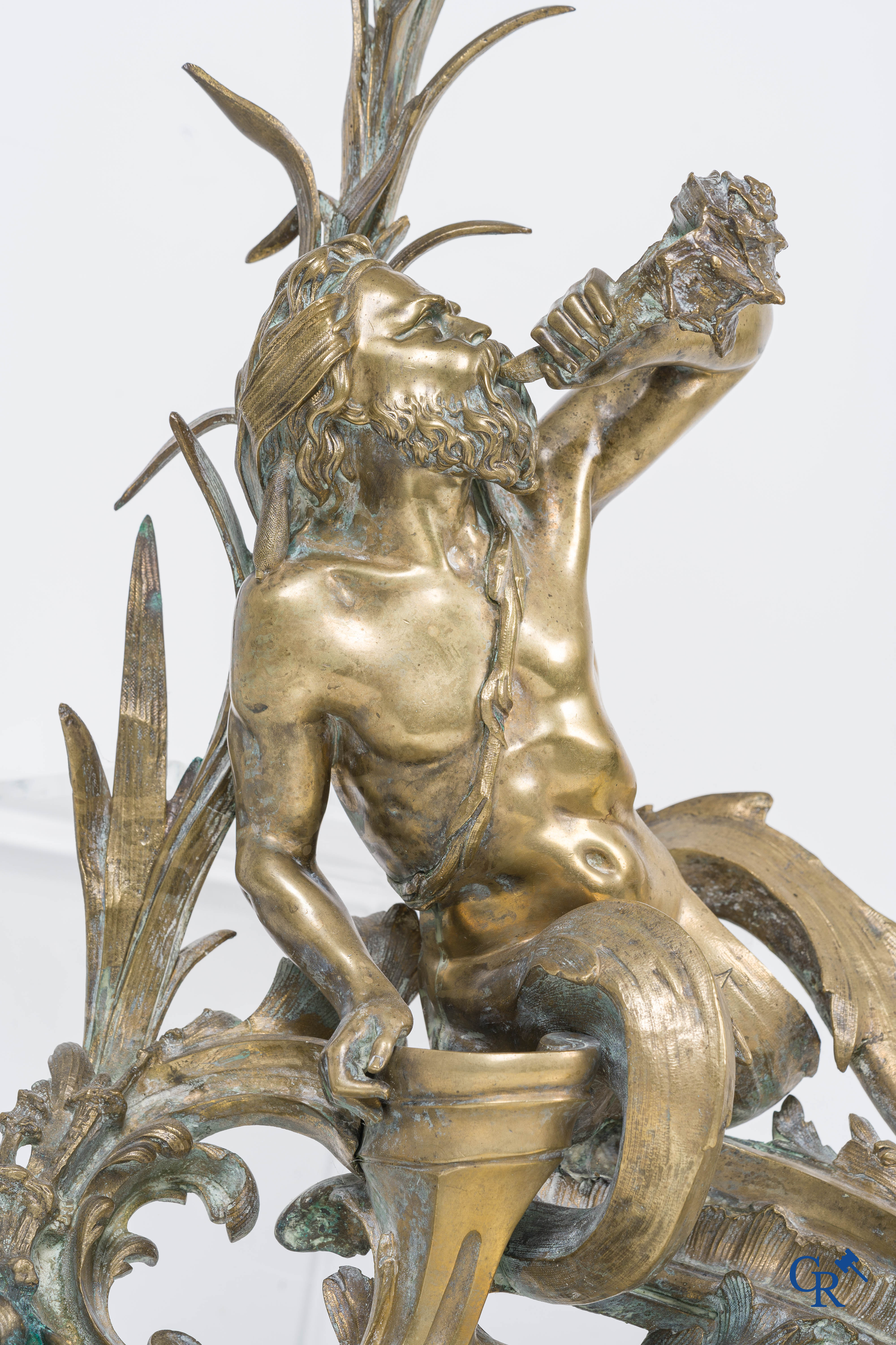 A large pair of finely chiseled bronze chenets with Tritons. Louis XV style. Napoleon III period.