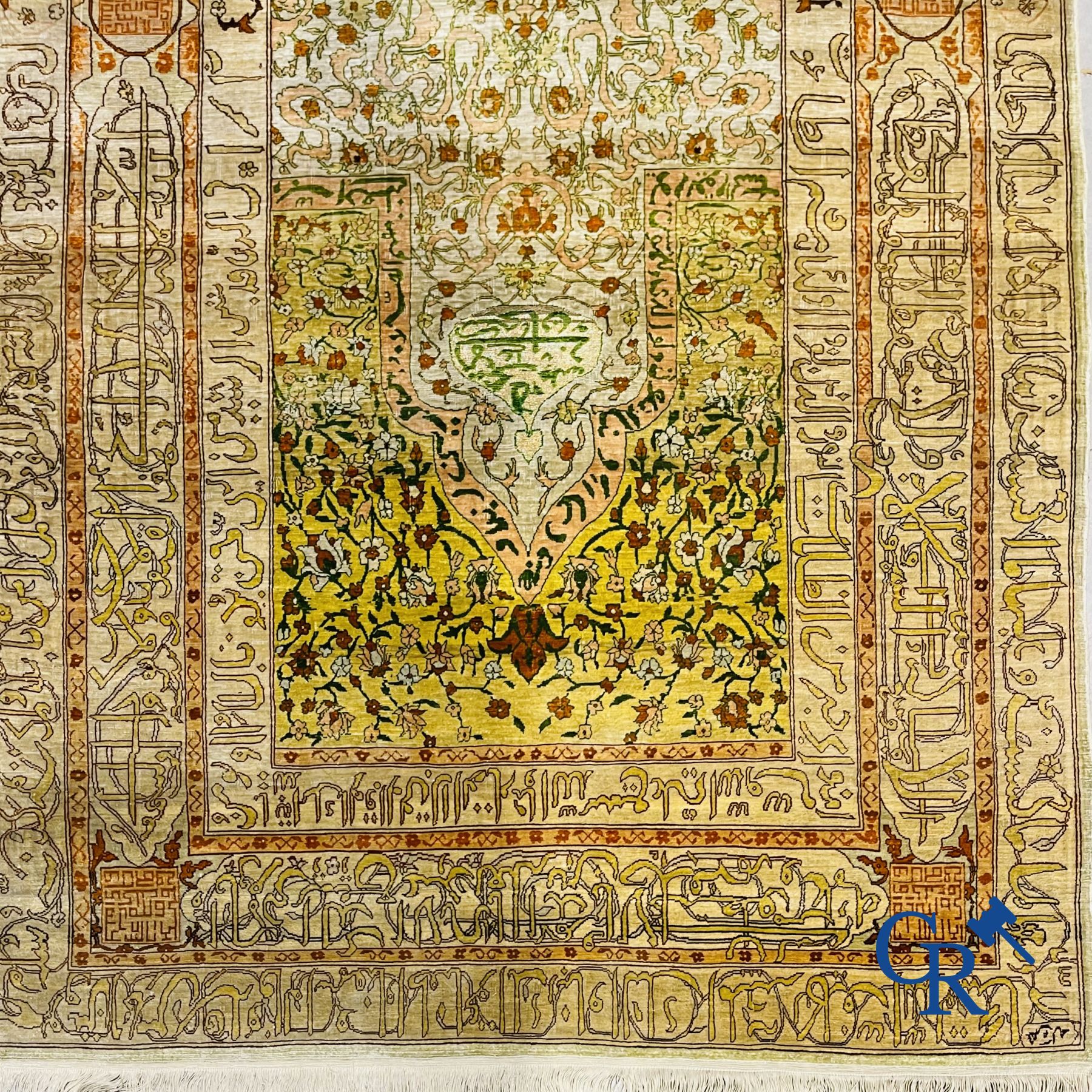 Oriental carpets: An exceptionally signed carpet in silk and gold thread with verses and a floral decor.