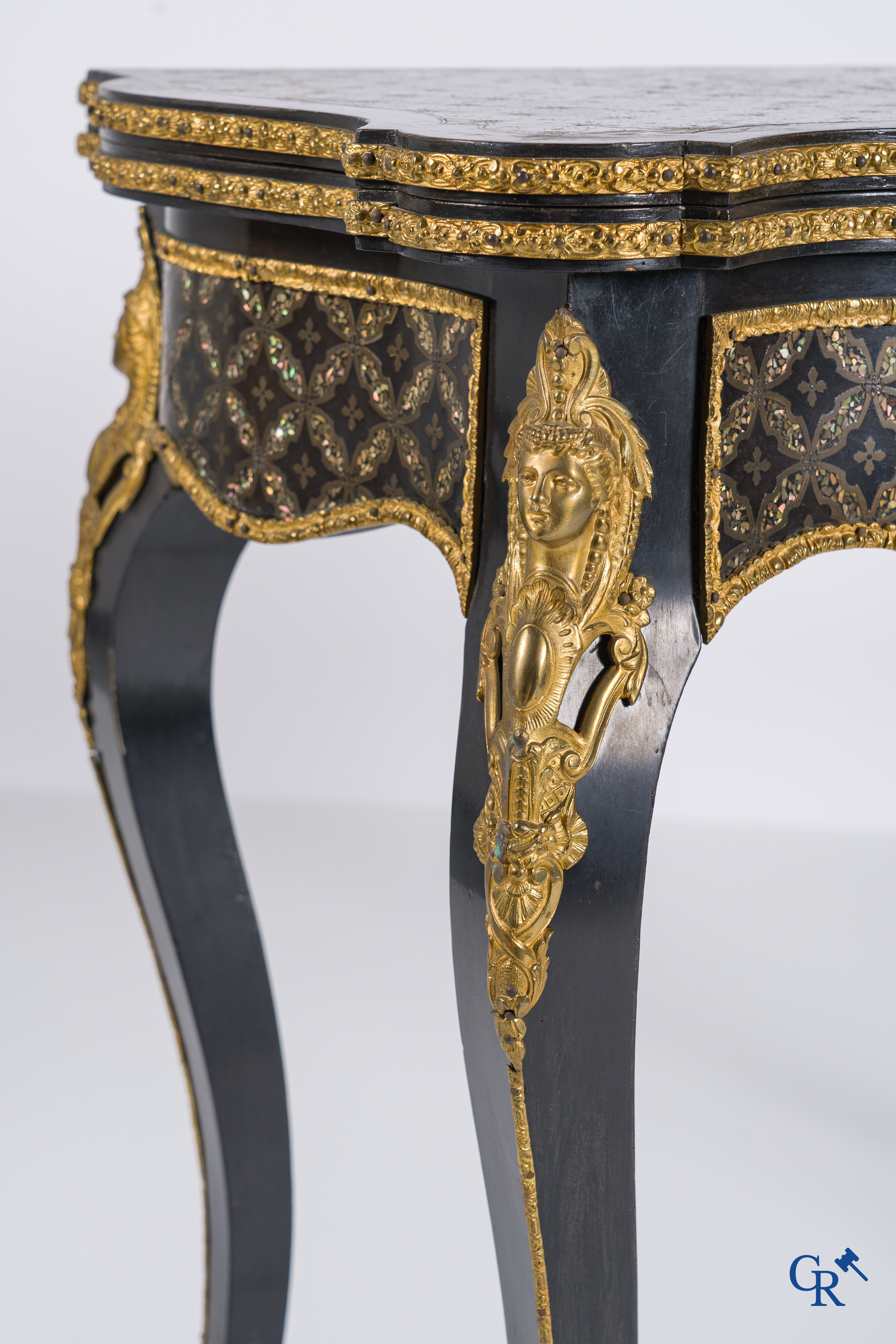 A card table with finely gilded bronze ornaments and inlay of copper and mother-of-pearl, circa 1880.