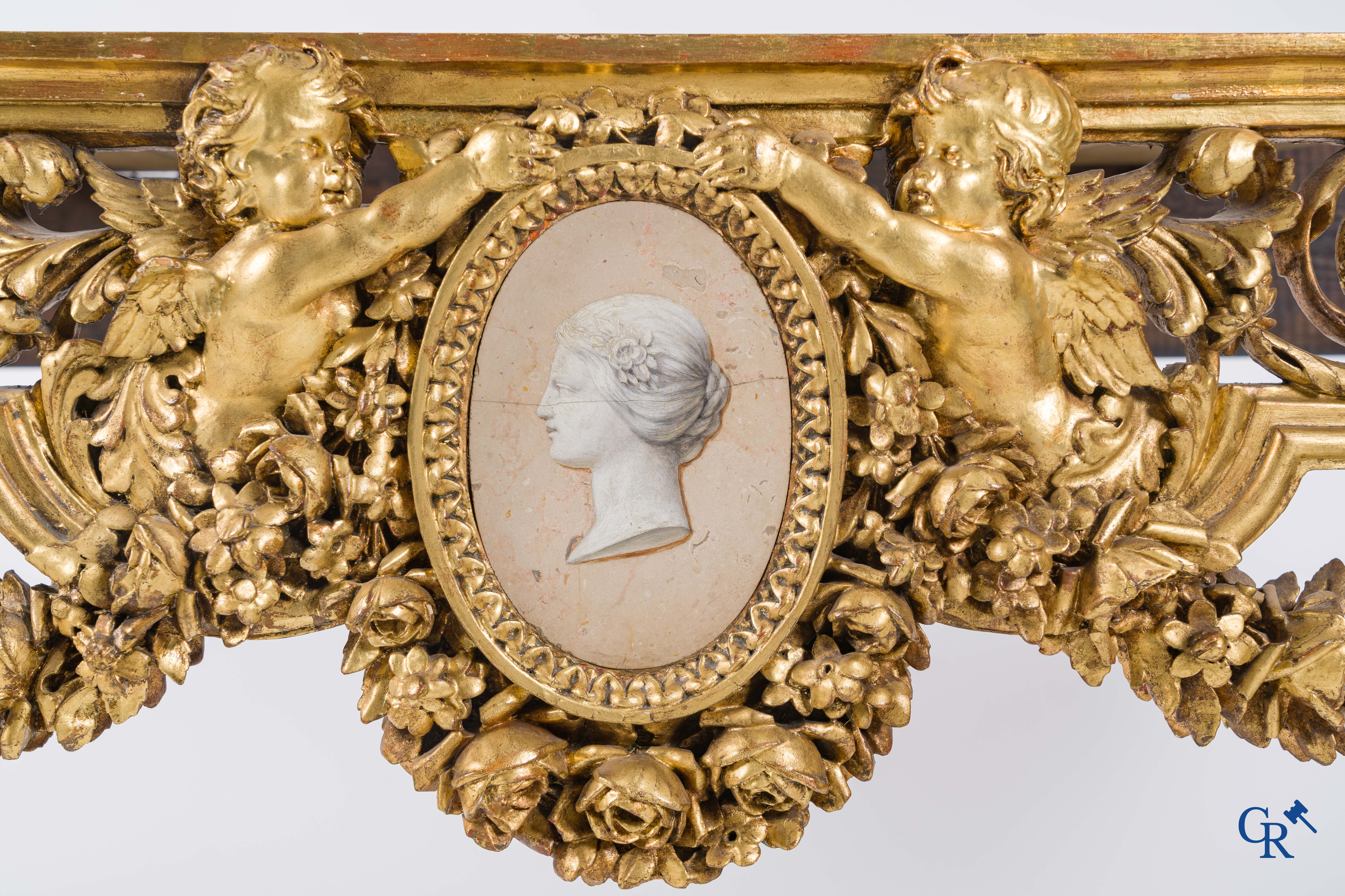 A richly carved and gilded console table in LVXI style with a grisaille painting on marble.