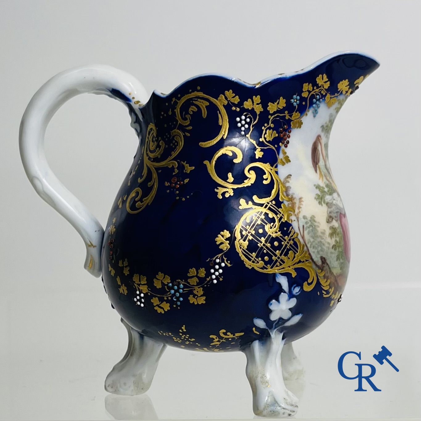 Vincennes 18th century. A three-legged milk jug in soft porcelain with lapis blue background.