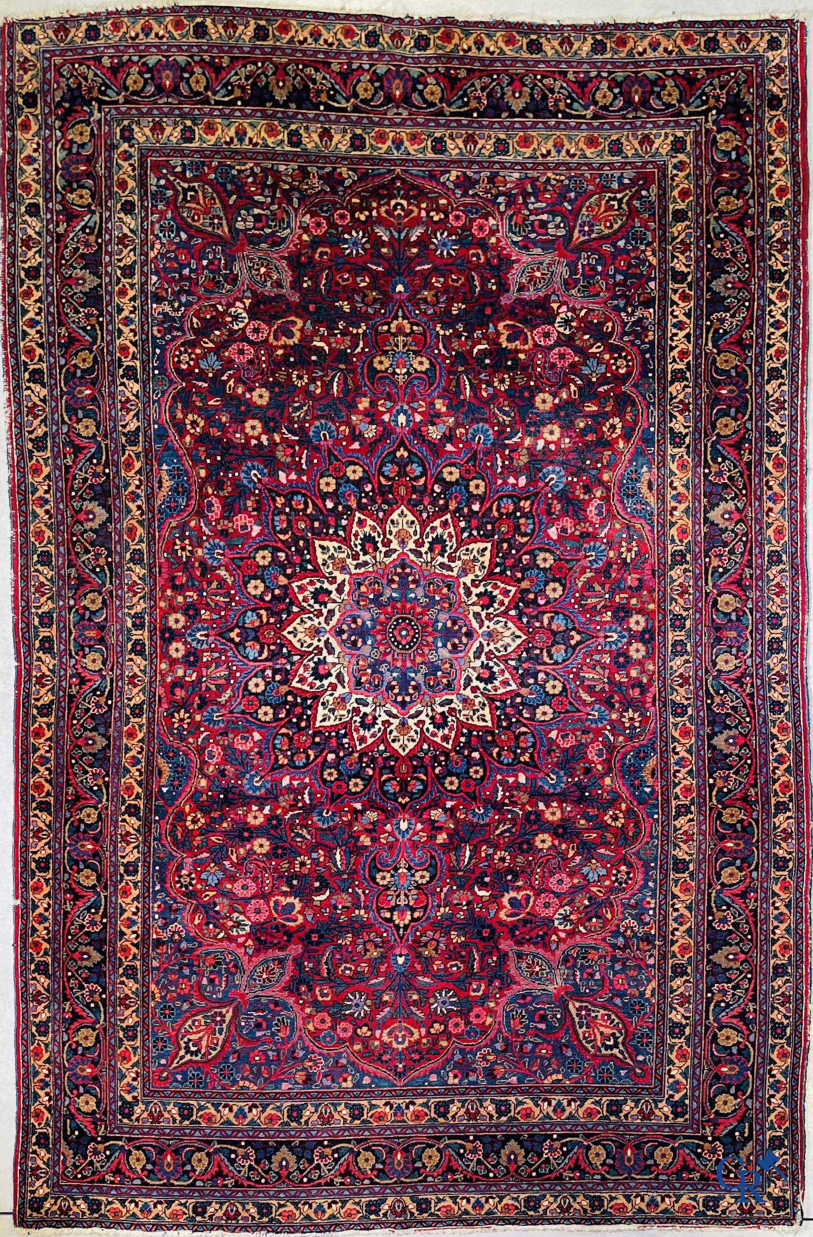 Oriental carpets: Iran, antique Persian carpet with dark red background.