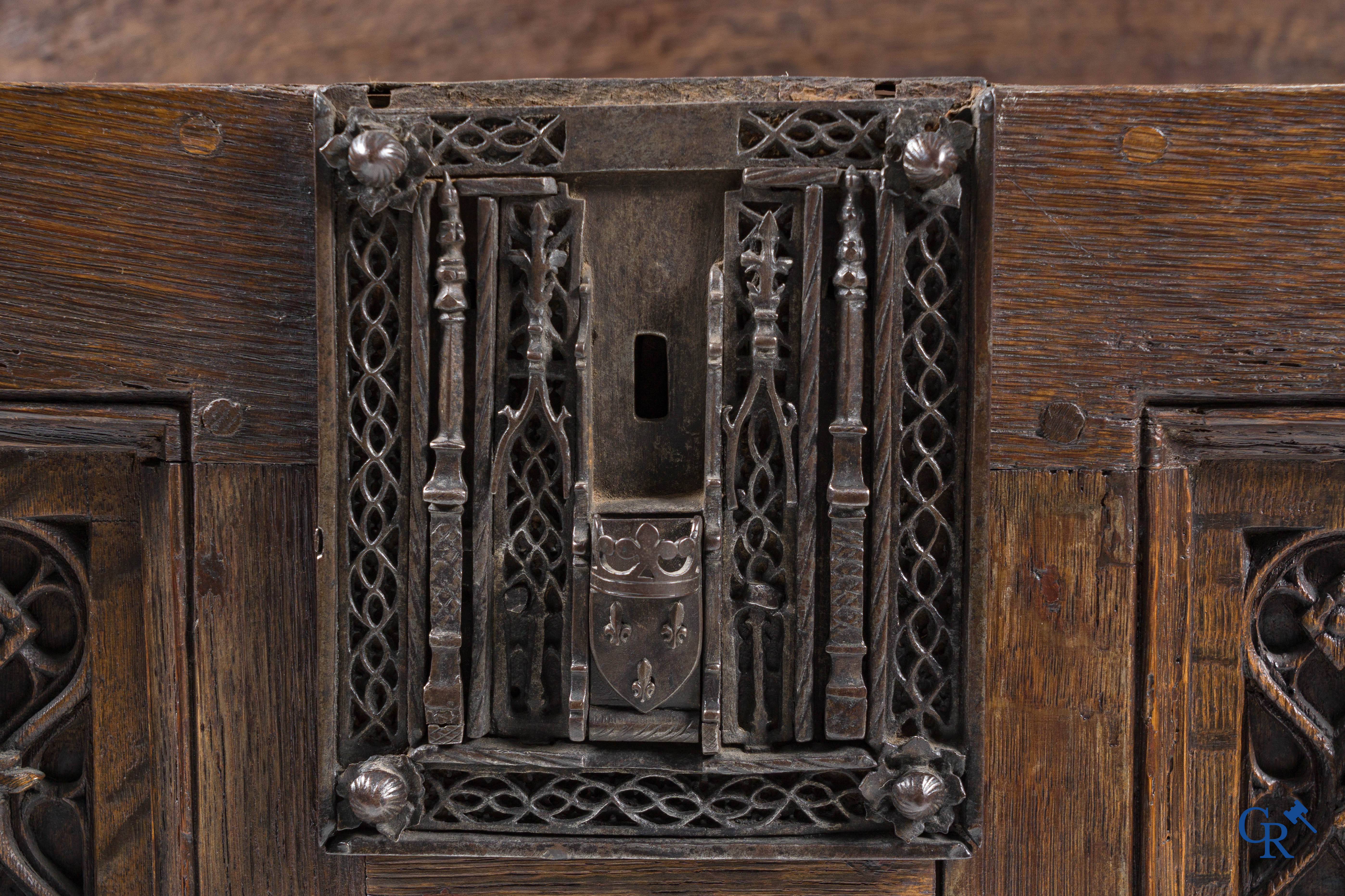 Gotiek. Een Gotische eikenhouten gesculpteerde koffer met zijn slotwerk in smeedijzer. 2de helft 15e eeuw.