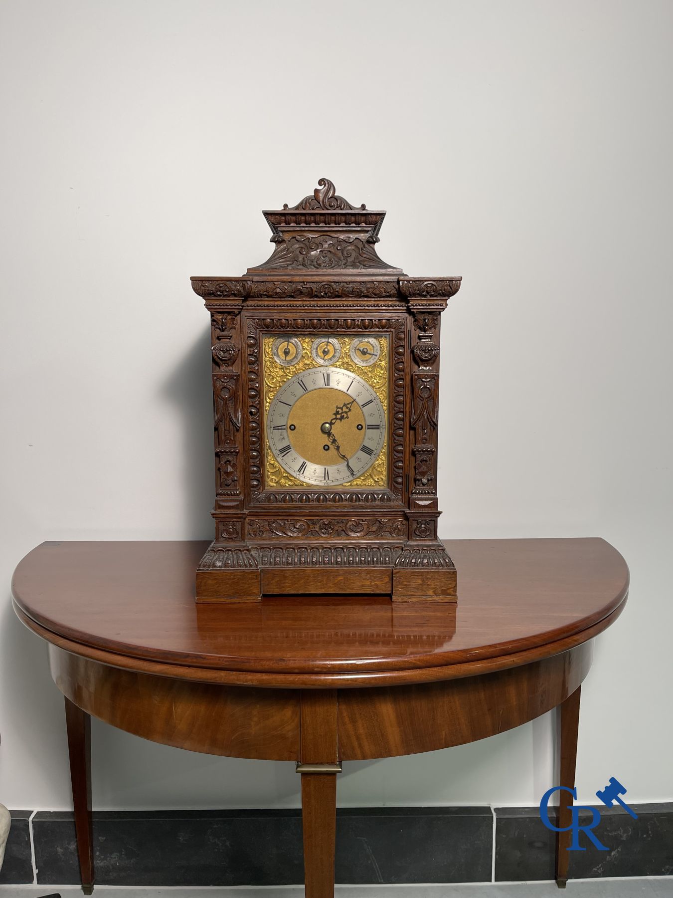 Clock with multiple bells and music in oak sculpted case with matching pedestal.