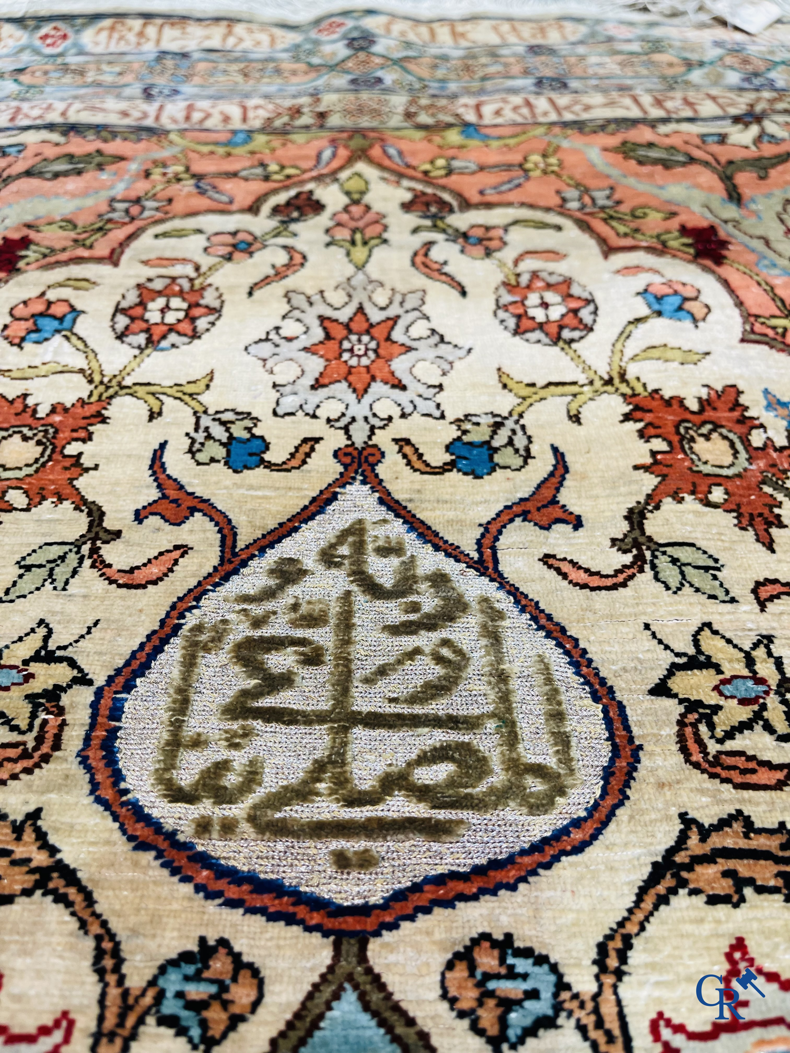 Oriental carpets, Hereke Turkey, a finely hand-knotted silk carpet with inscriptions and gold thread.