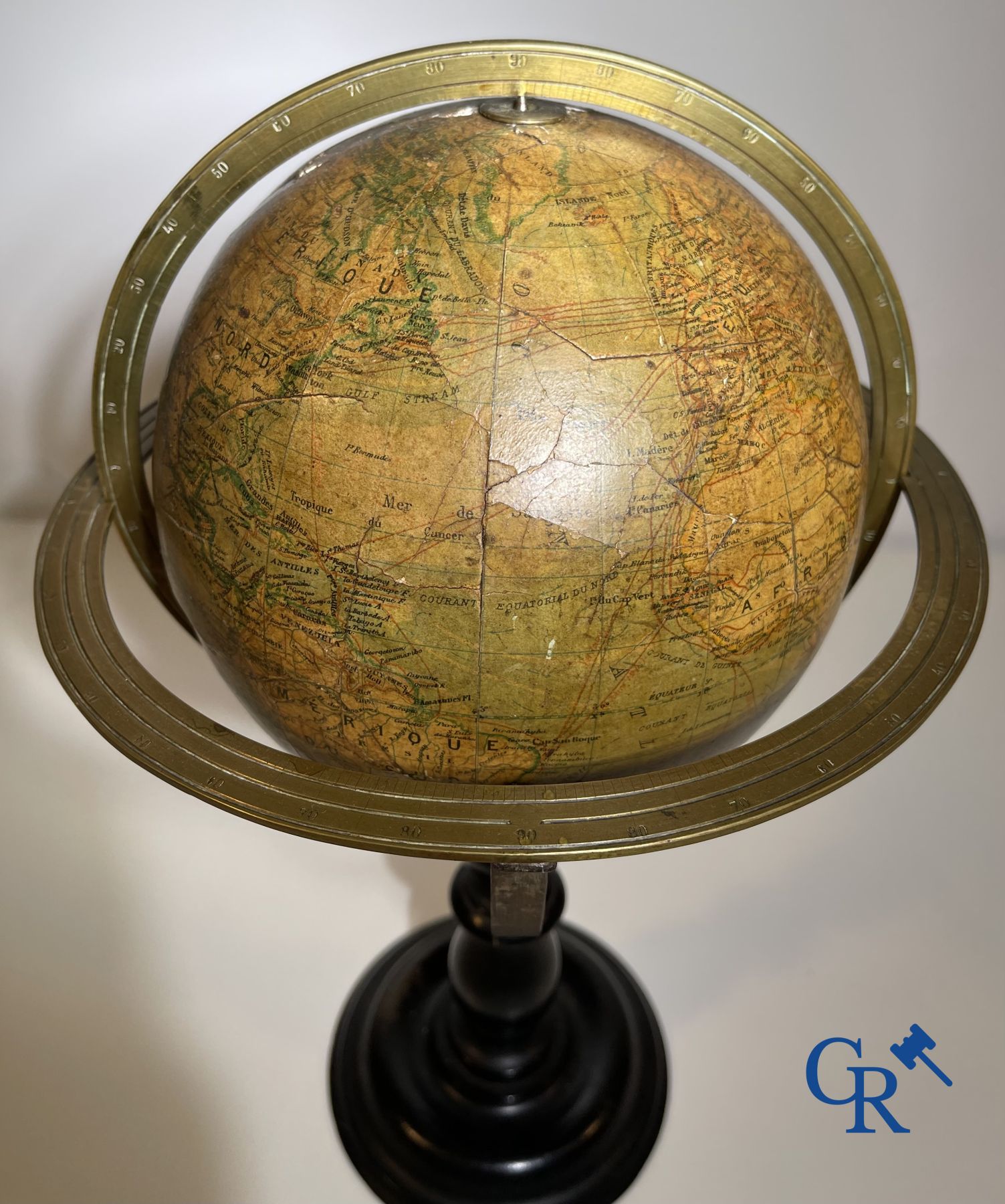 An antique globe with meridian circle on a black lacquered wooden base. 19th century.