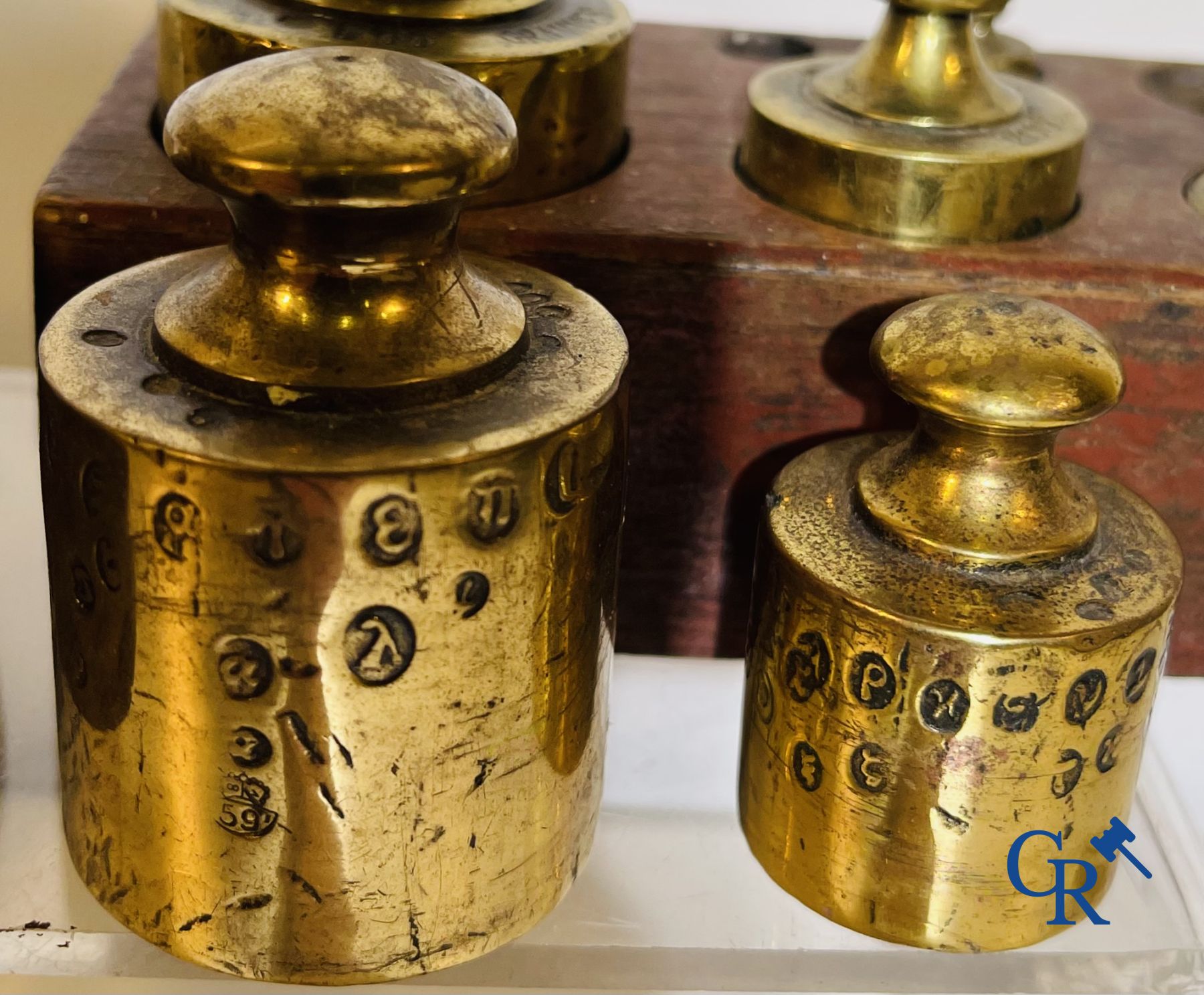 A various lot of antique calibration weights and a calibrated scale. 18th-19th century.