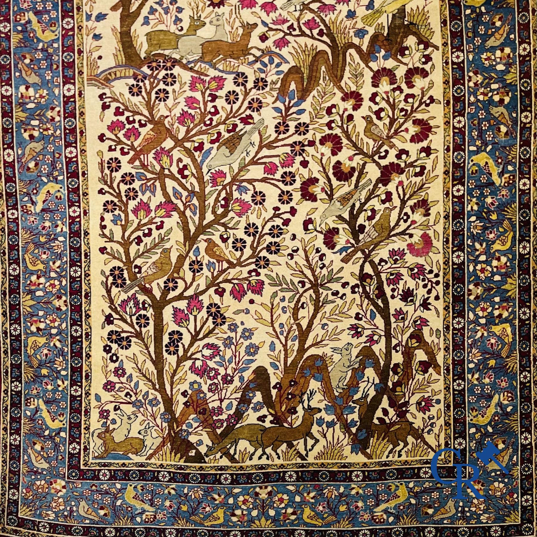 Oriental carpets: Antique oriental carpet with a decor of animals and birds in the forest.