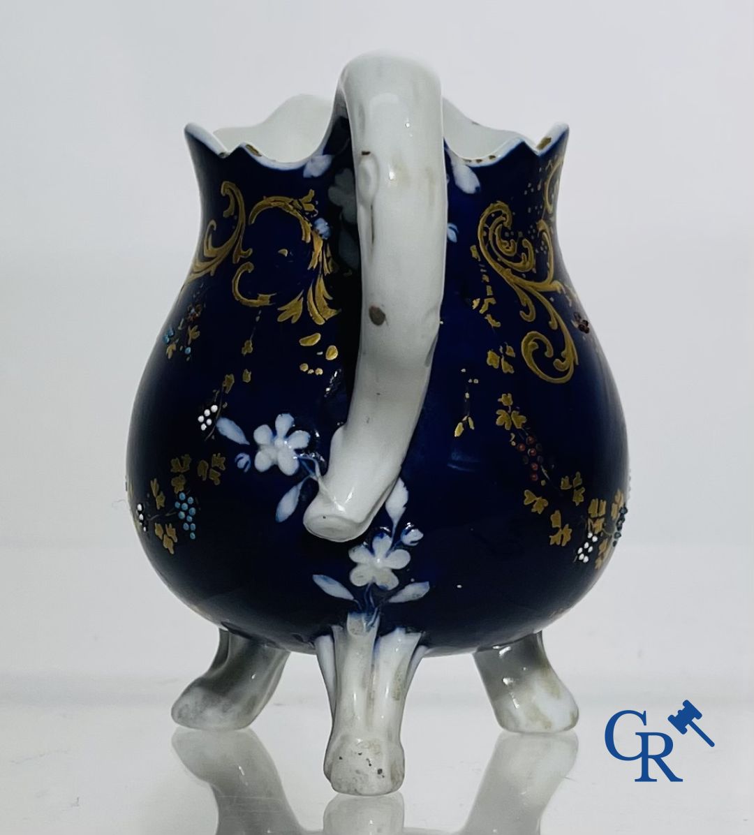 Vincennes 18th century. A three-legged milk jug in soft porcelain with lapis blue background.