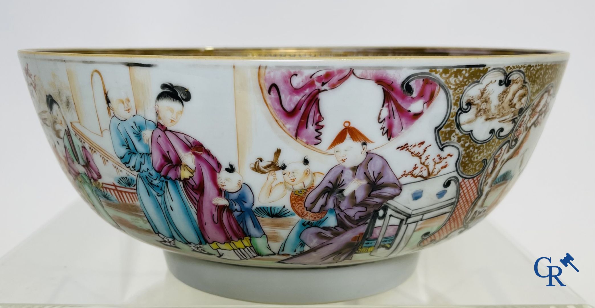 A large Chinese famille rose mandarin bowl, a famille rose cup and saucer and a figurine in blanc de chine.