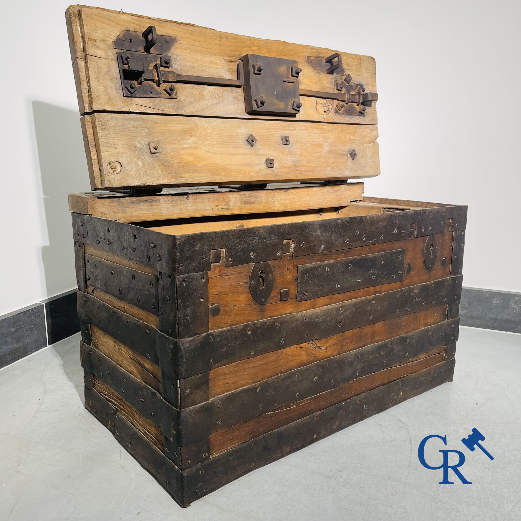 Antique wooden chest with hardware and lockwork in forging.