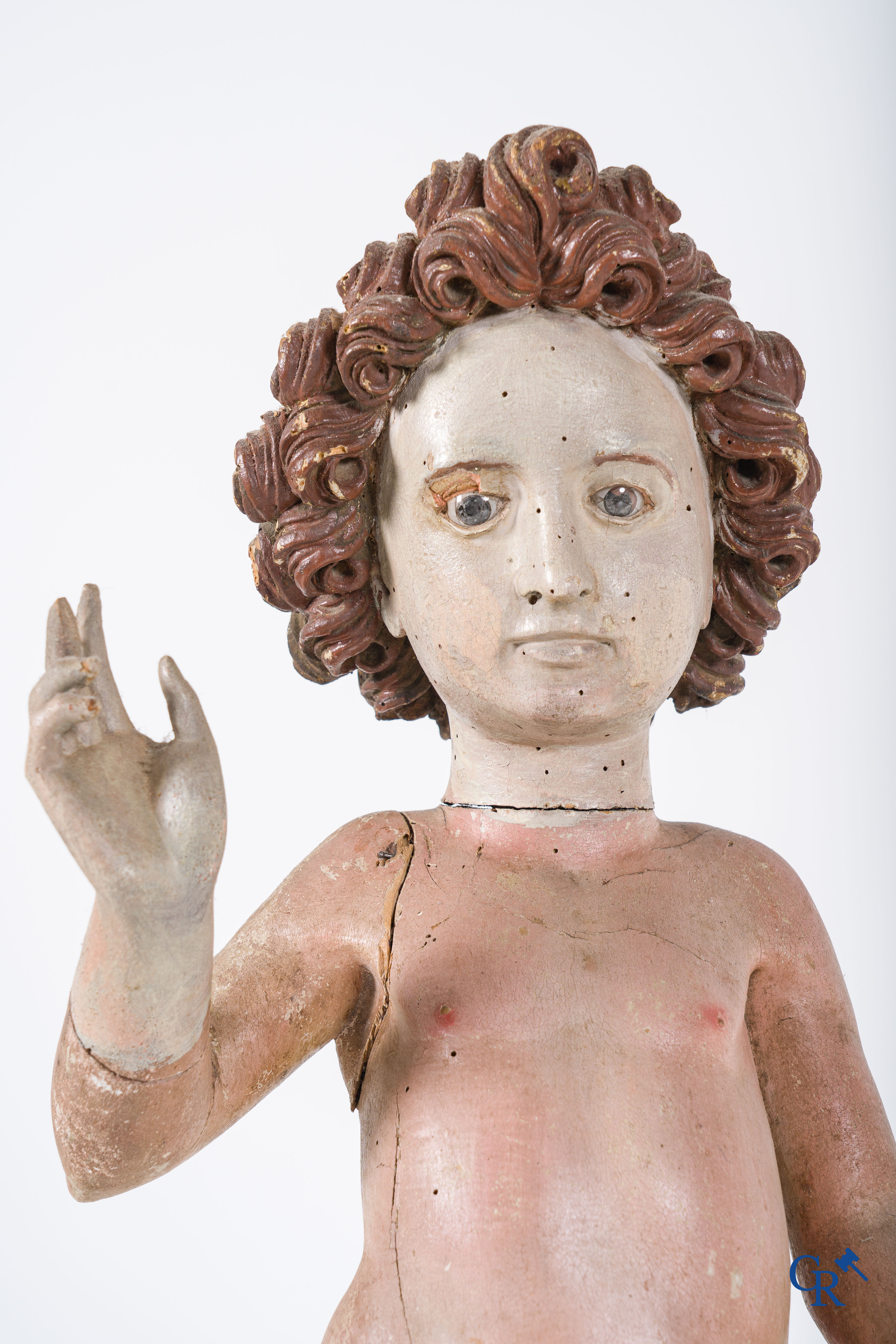 Religious objects. A polychrome wood sculpture depicting the child Jesus in Salvator Mundi. 17th-18th century.