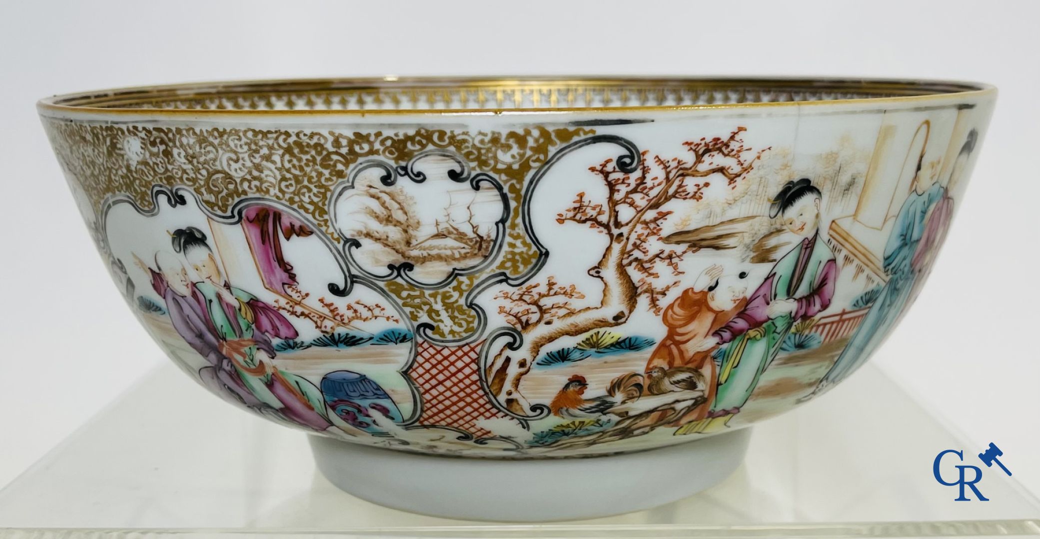 A large Chinese famille rose mandarin bowl, a famille rose cup and saucer and a figurine in blanc de chine.