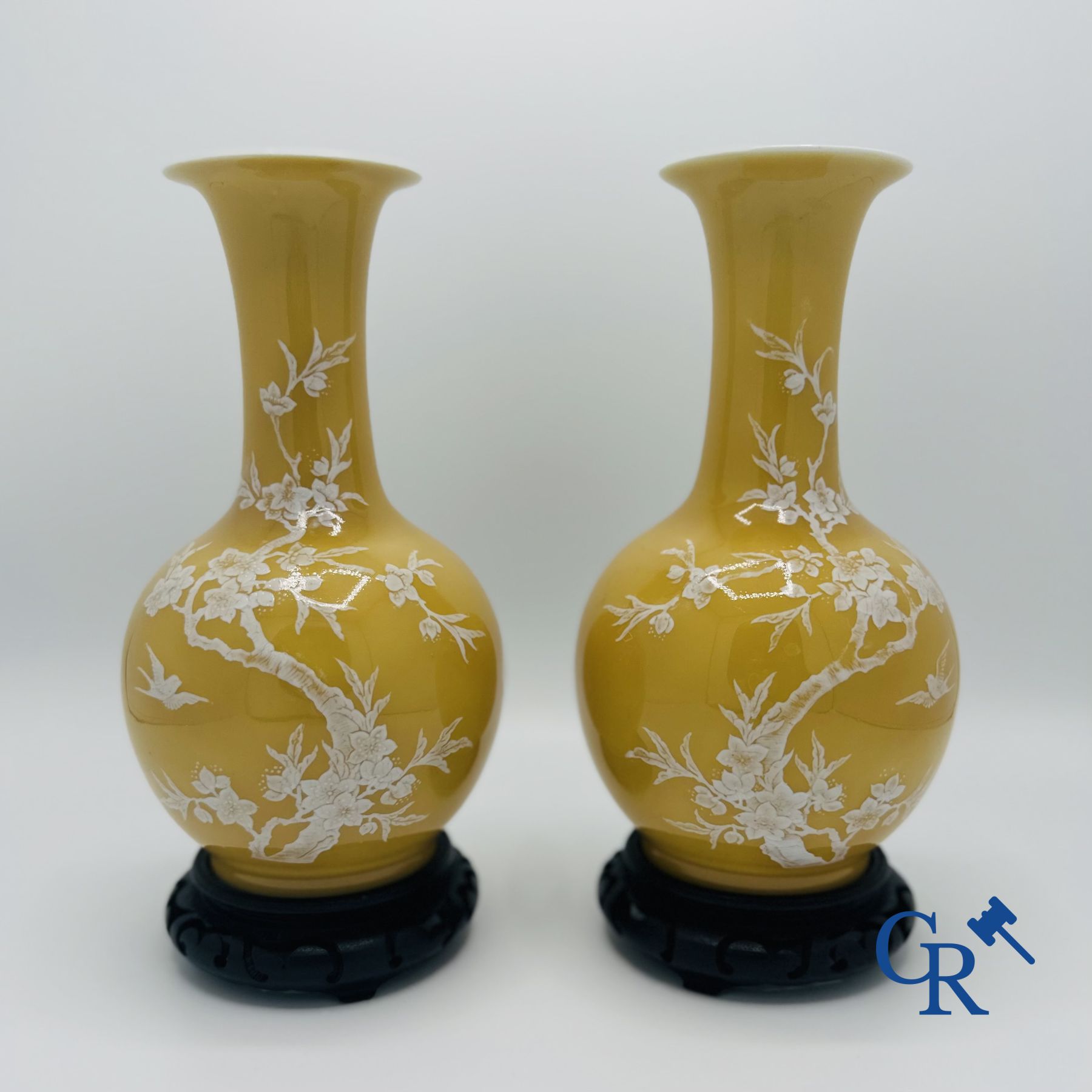 Chinese porcelain: Pair of Chinese vases with a floral decor on a yellow glazed surface. 20th century.