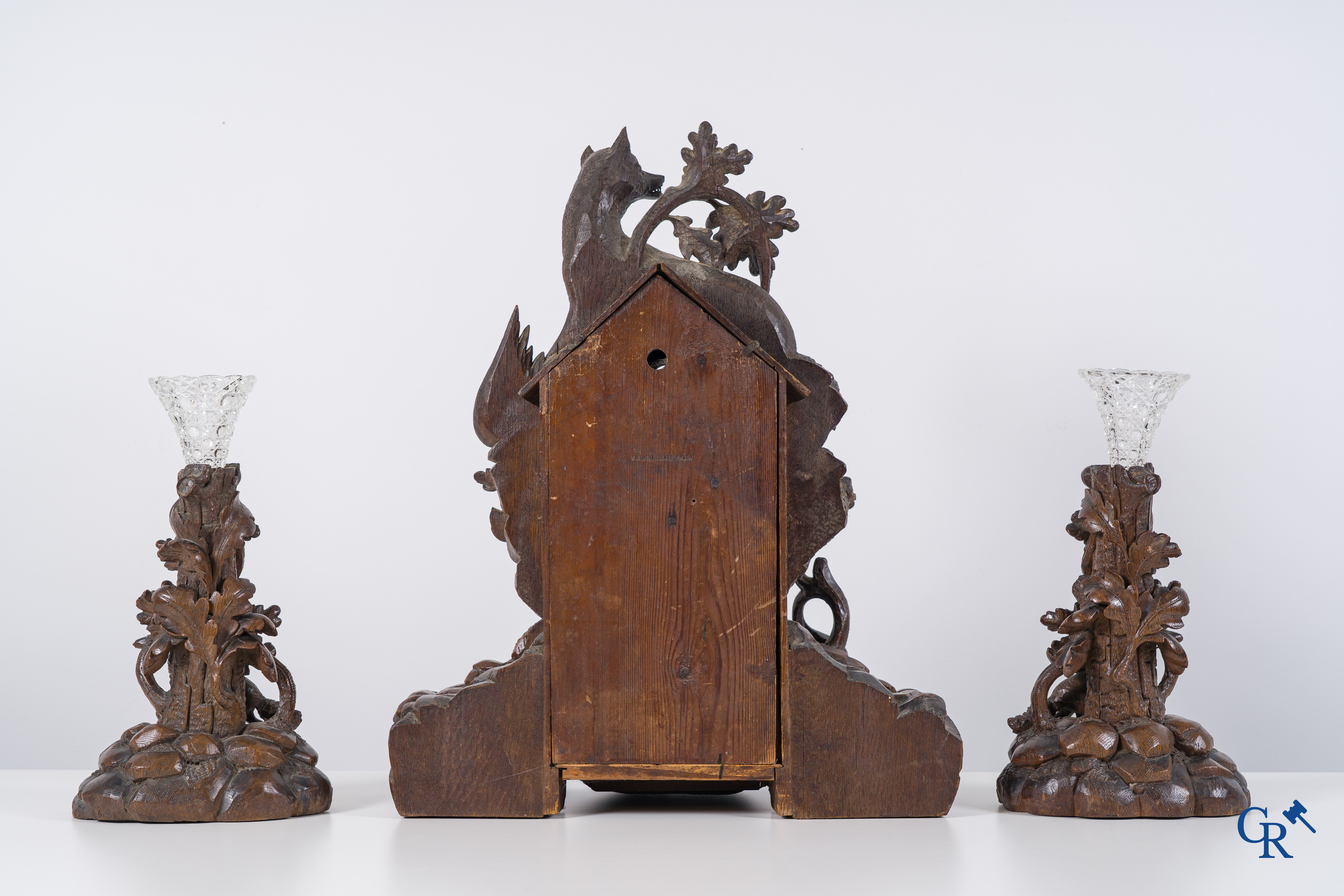 Black Forest, circa 1900. A large 3-piece cuckoo clock in sculpted wood.