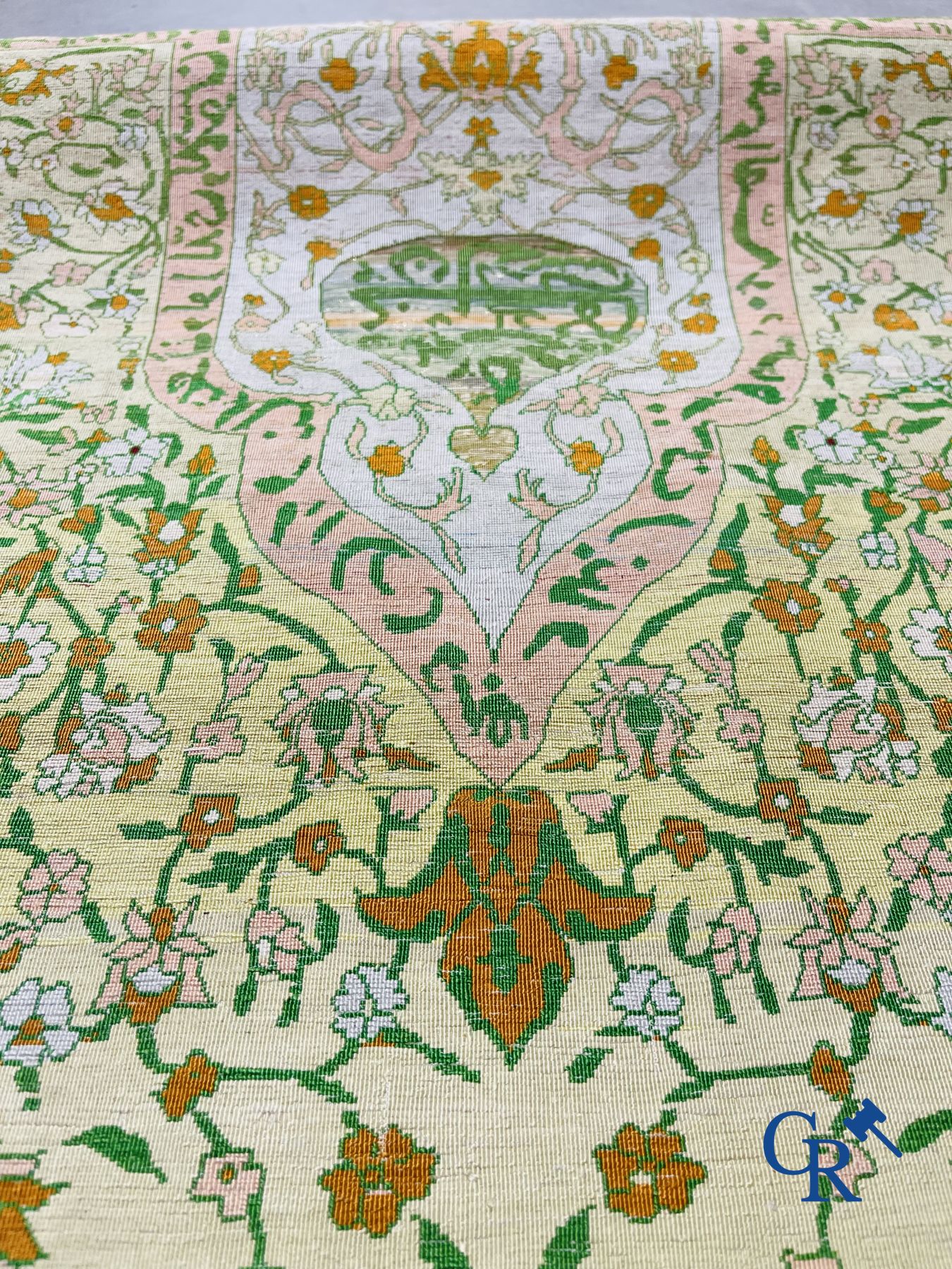 Oriental carpets: An exceptionally signed carpet in silk and gold thread with verses and a floral decor.